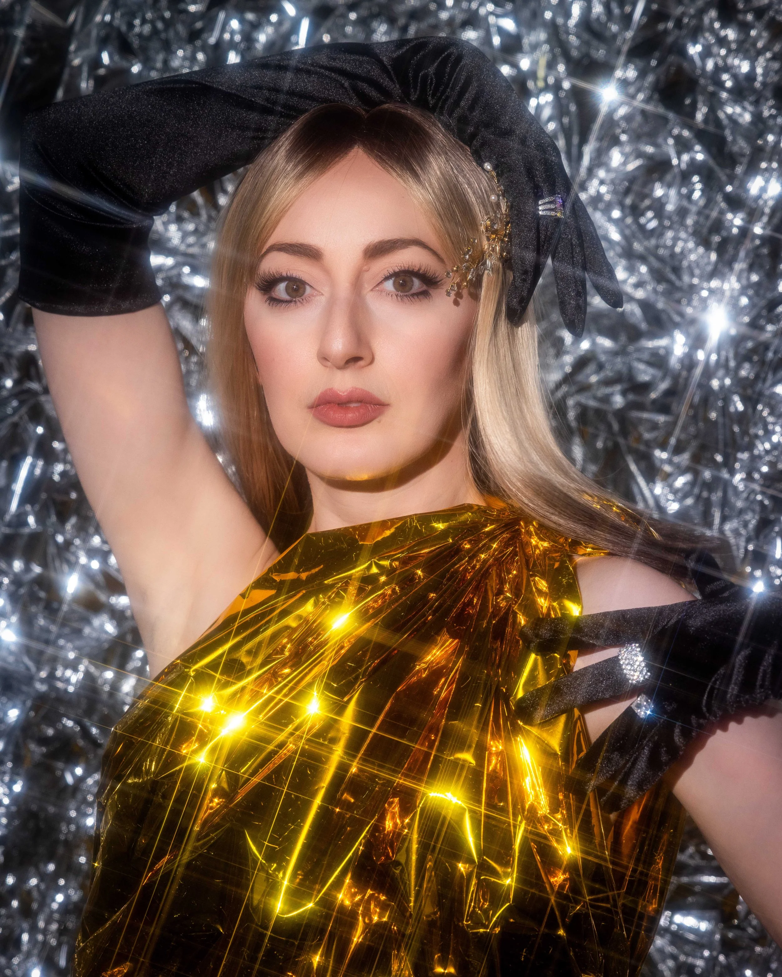 Fashion portrait with gold reflective material enhanced by starburst filter light effects