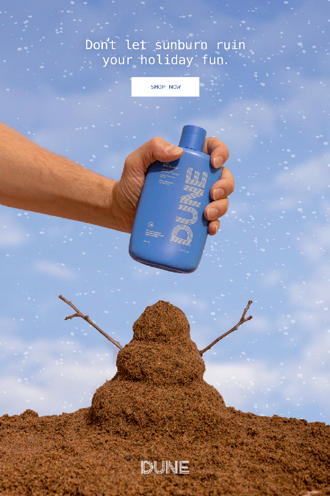 Minneapolis-based commercial product, skincare, and CPG photographer Emily Schadow photographed a Hand holding a blue bottle labeled DUNE smashing a snowman made out of sand with blue sky background holiday festive.