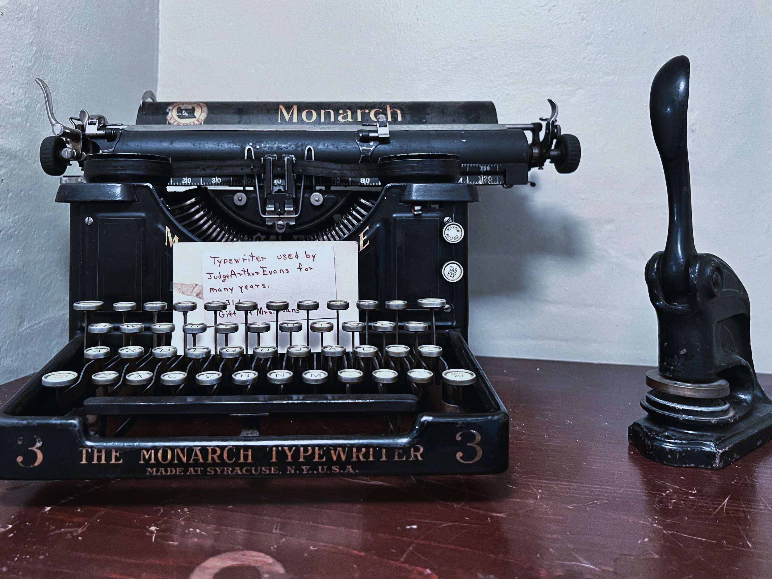 Vintage Monarch typewriter and hand press displayed in the haunted Airbnb.jpg