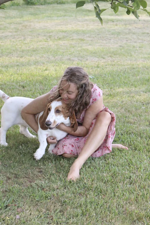Nikki Freeman sitting outdoors with her dog in Asheville lifestyle setting