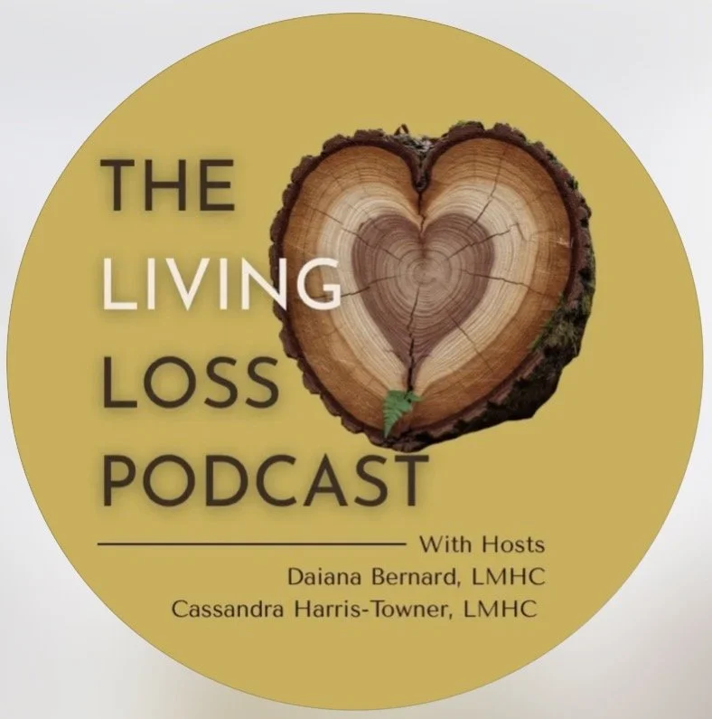 Logo of the Living Loss Podcast featuring a wooden heart-shaped tree ring with bark on the edges, yellow background, and text indicating hosts Daiana Bernard and Cassandra Harris-Towner.