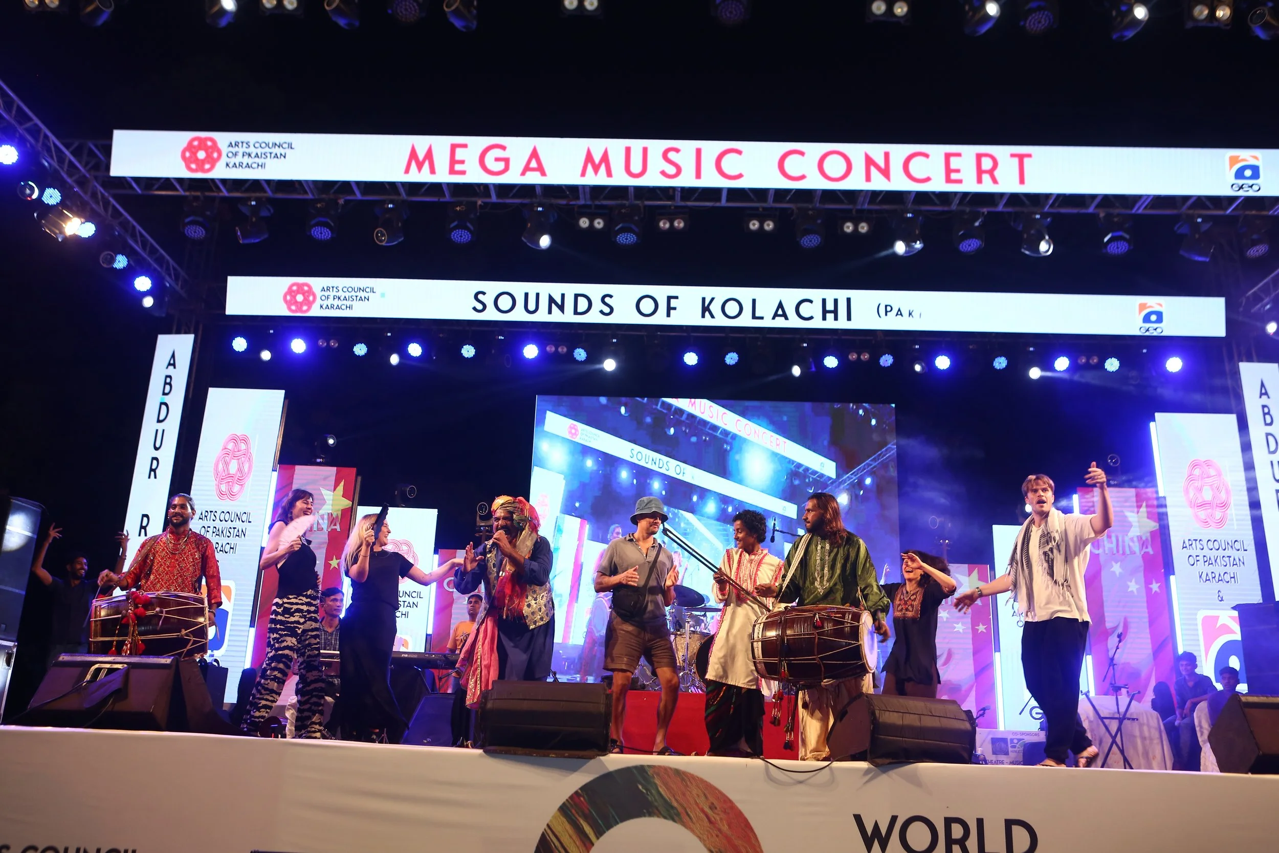 Alex Liu, Bonnie J. Evans, Sarah Dillamore, Erica Lauren Wise, and Christopher Kelly dance on stage at Mega Music Concert 2.0, Karachi, Pakistan, October 2024