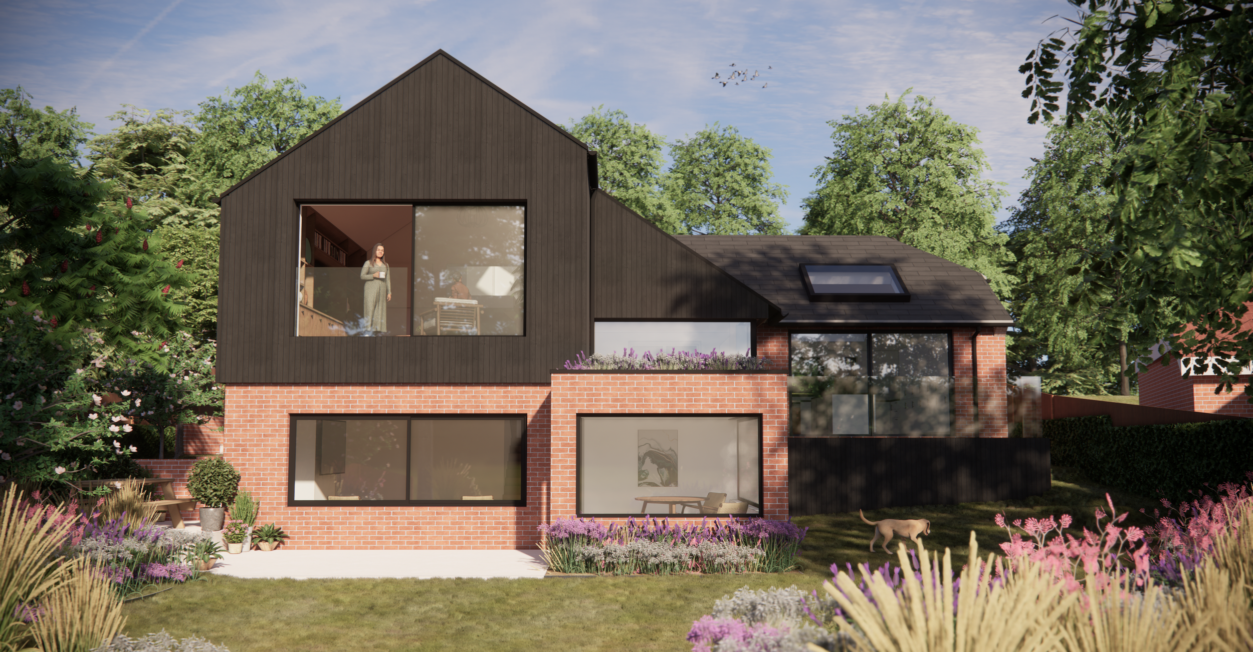 Modern extension with black timber cladding and red brick walls. Modern glazing, juliette balcony with glass balustrade black window frames. Garden landscaping.