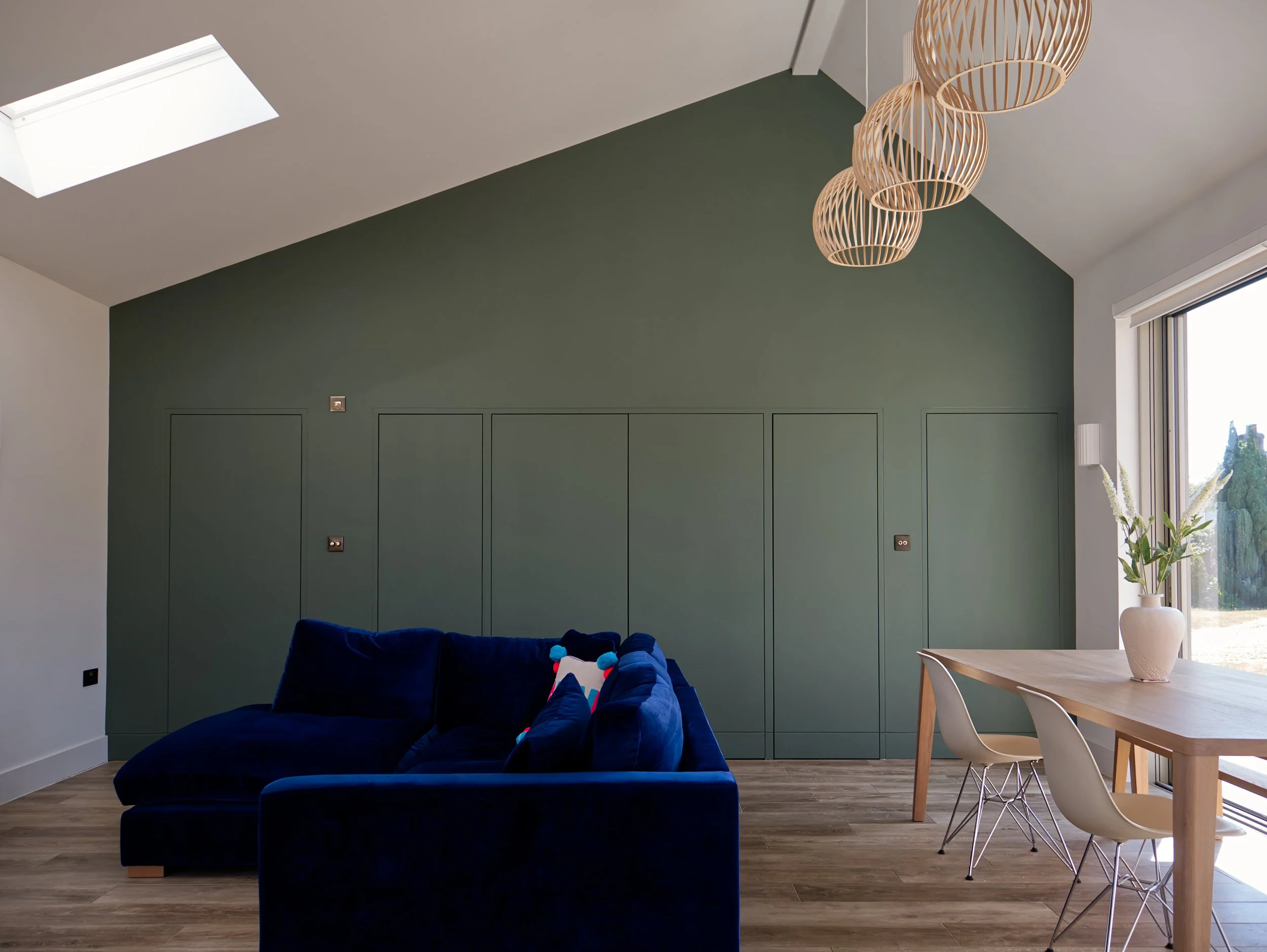 Built in green cupboards, a symetrical pitched roof, brass switches and sockets