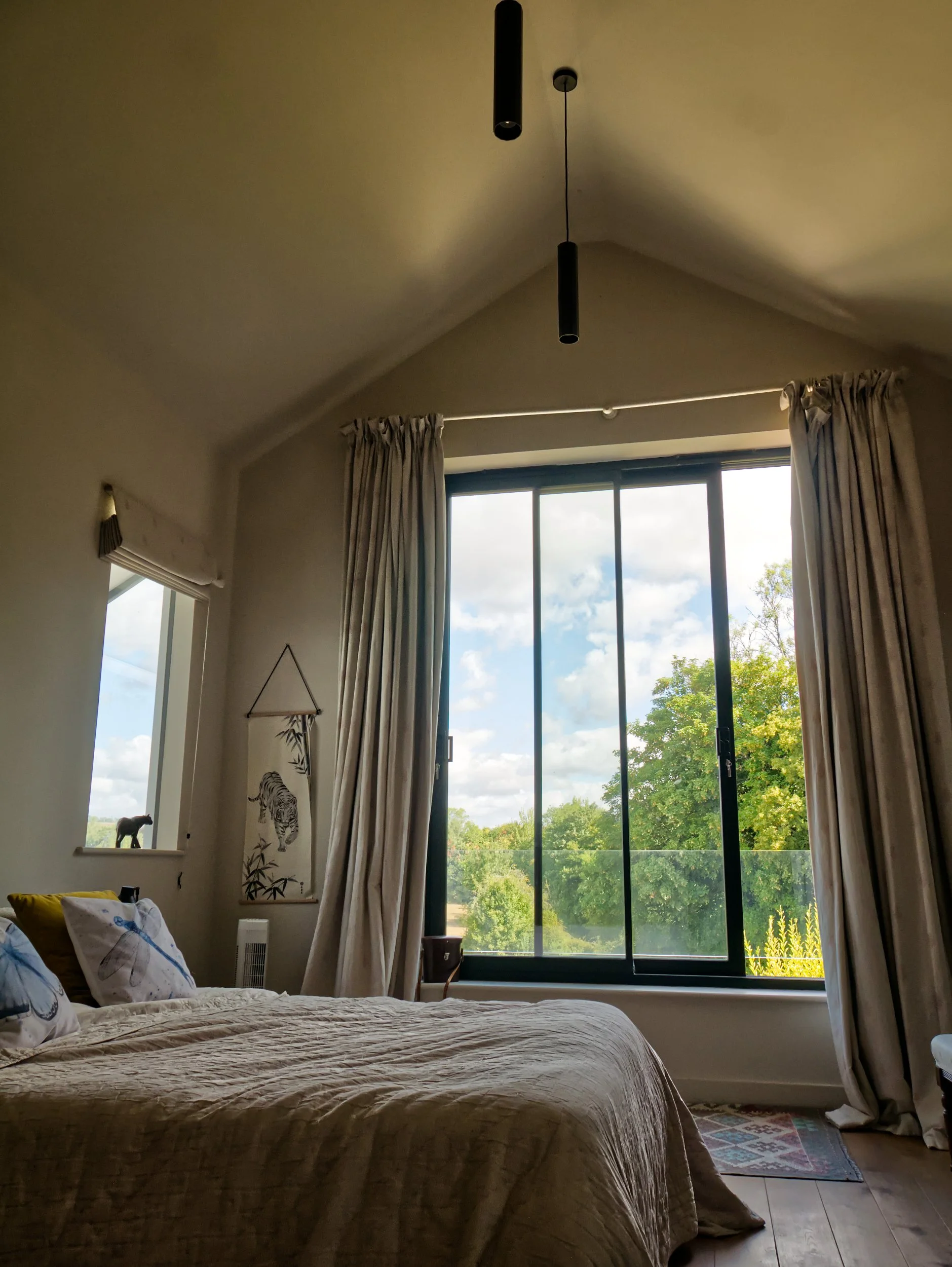 Pitched roof bedroom with sliding window and green view