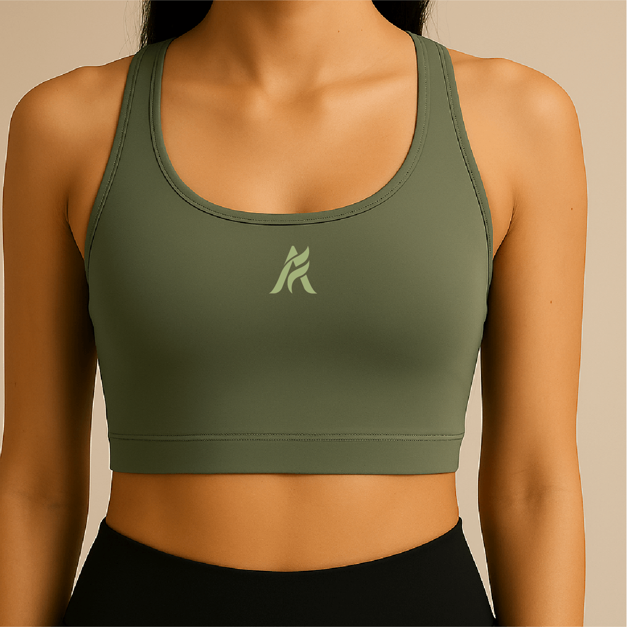 A woman wearing a green sports bra with a logo on the chest.