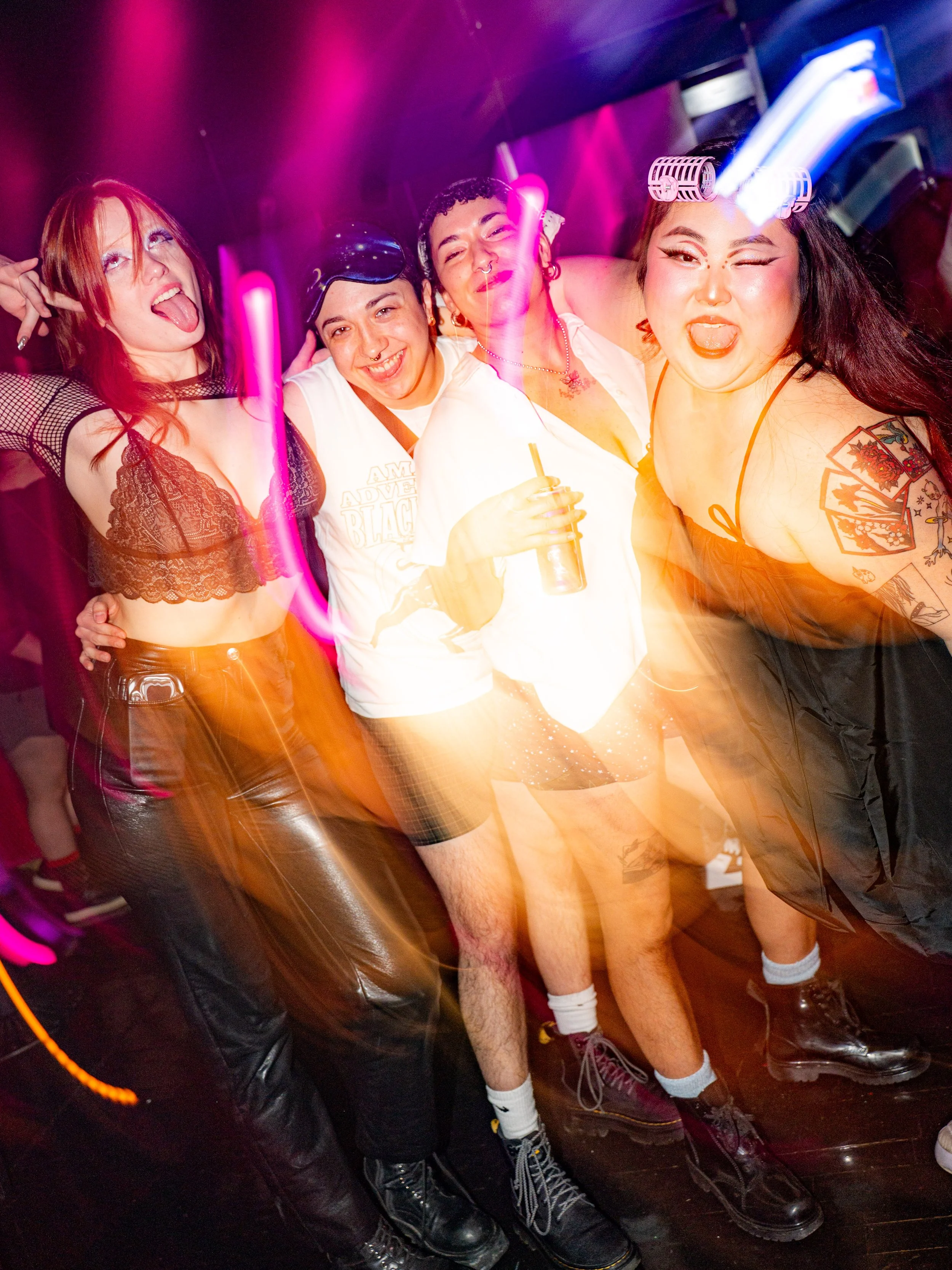 Group of young women at a party, dancing, with neon lights and motion blur effects.