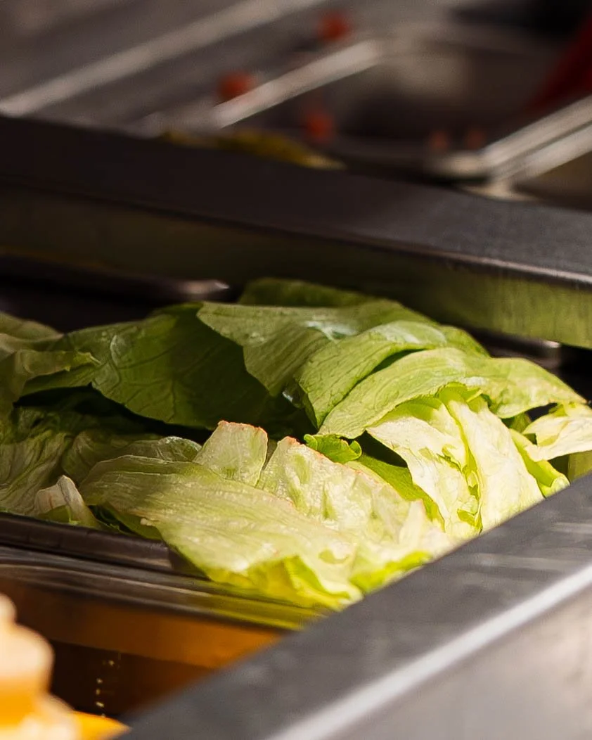 Iceberg lettuce in a cafeteria tray.