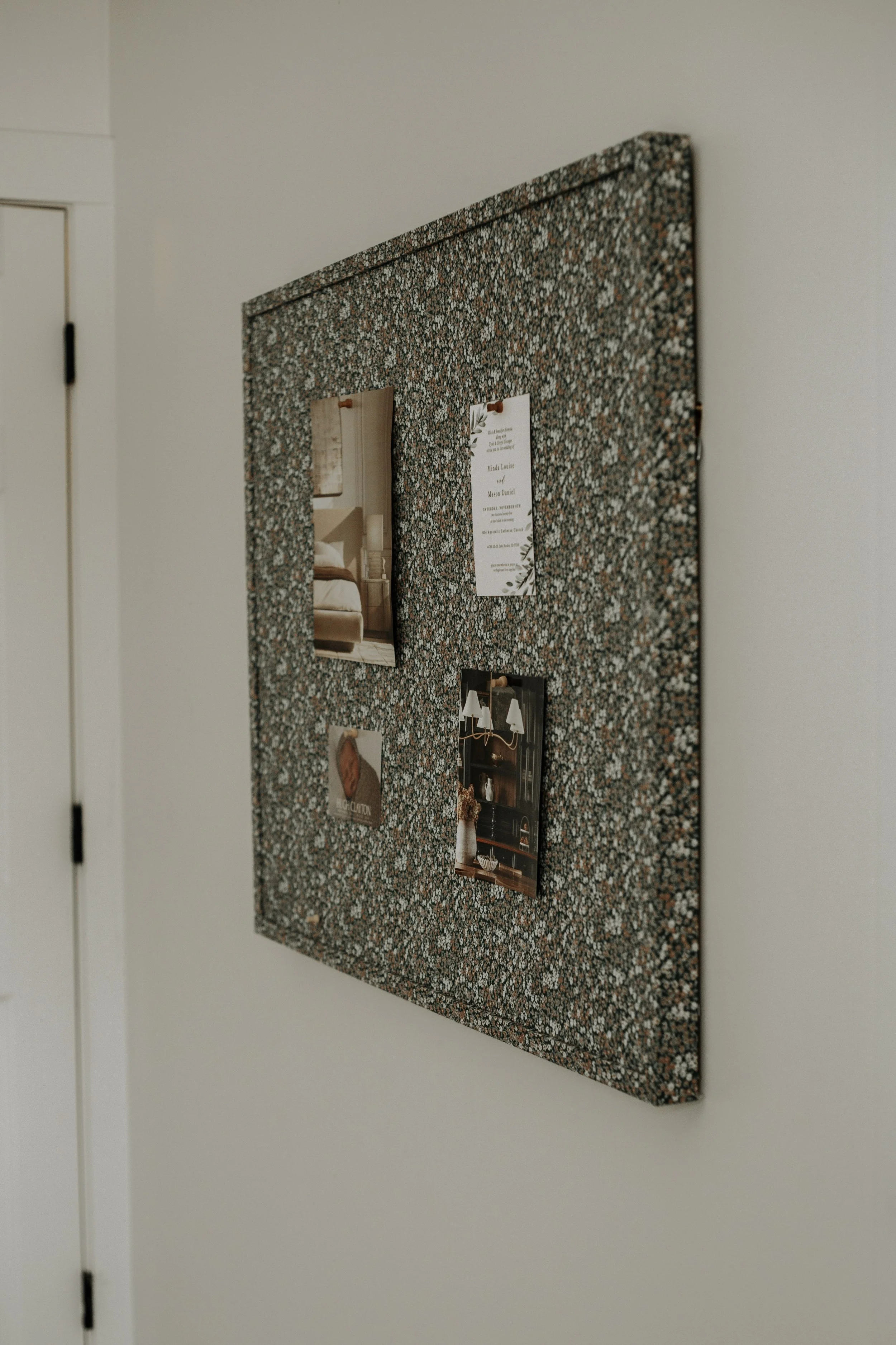 Floral bulletin board in a cozy bedroom with layers.