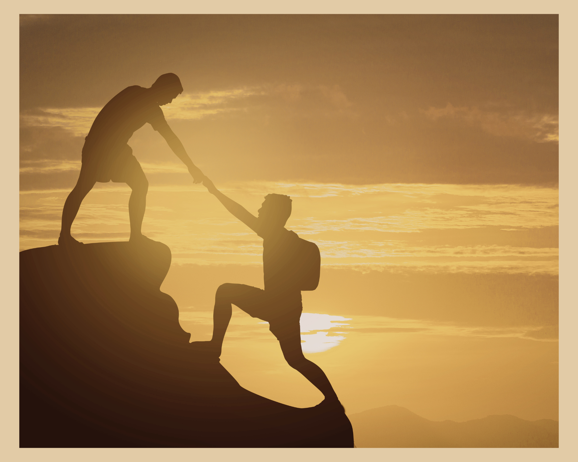 Silhouette of two people rock climbing