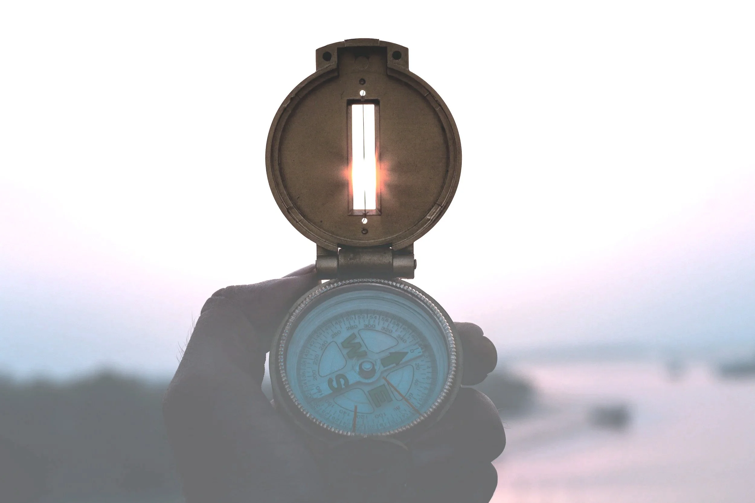 hand holding a compass