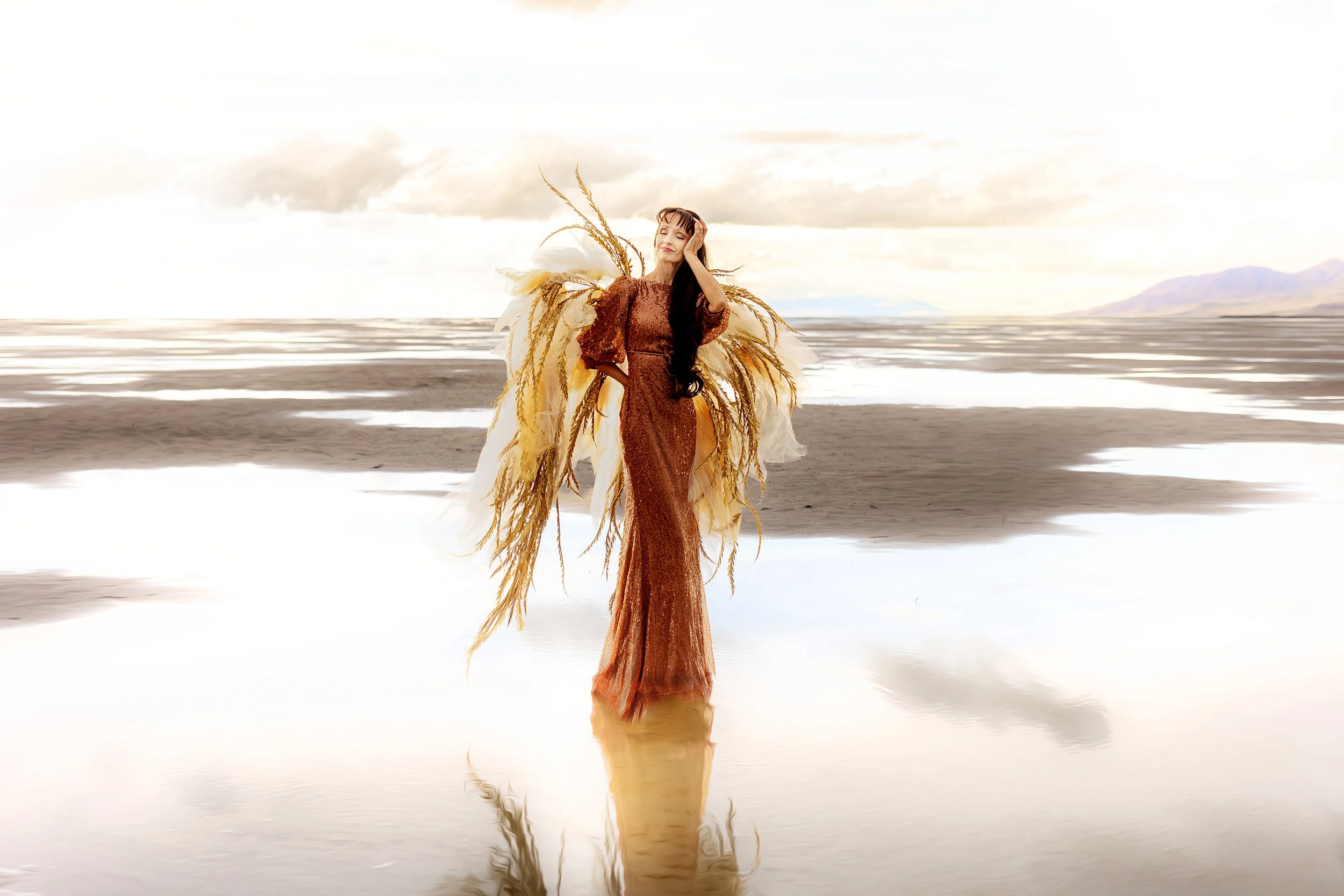 woman wearing a gown and unfinished wings standing in water at the Great Saltair