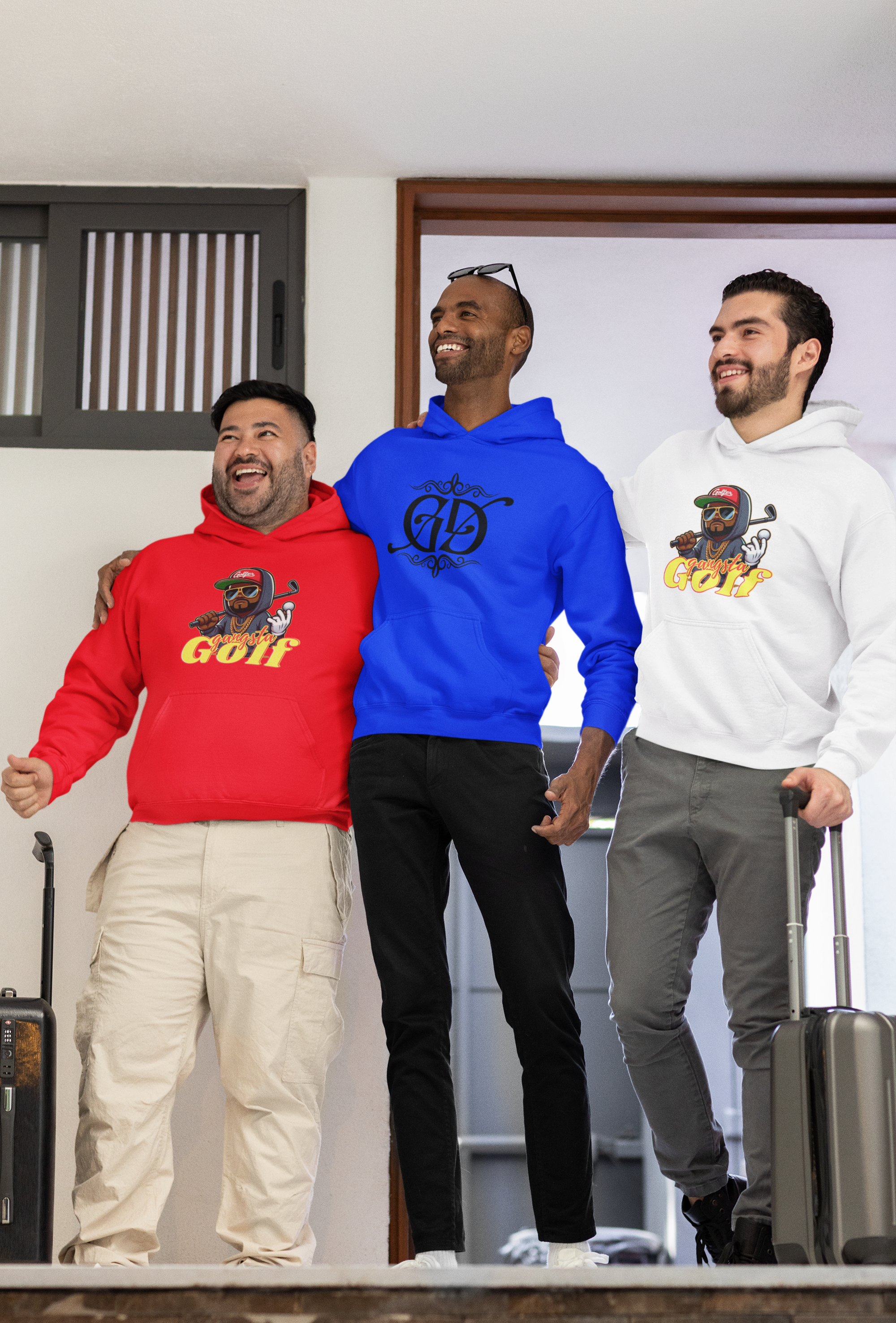 Three men wearing colorful hoodies, smiling and standing together, with two of them holding luggage.