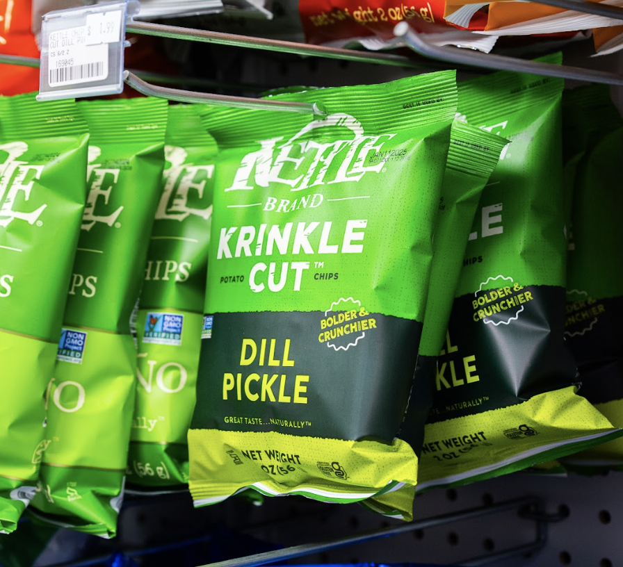 Packaged Kraut Krinkle Cut potato chips with dill pickle flavor on store shelf.