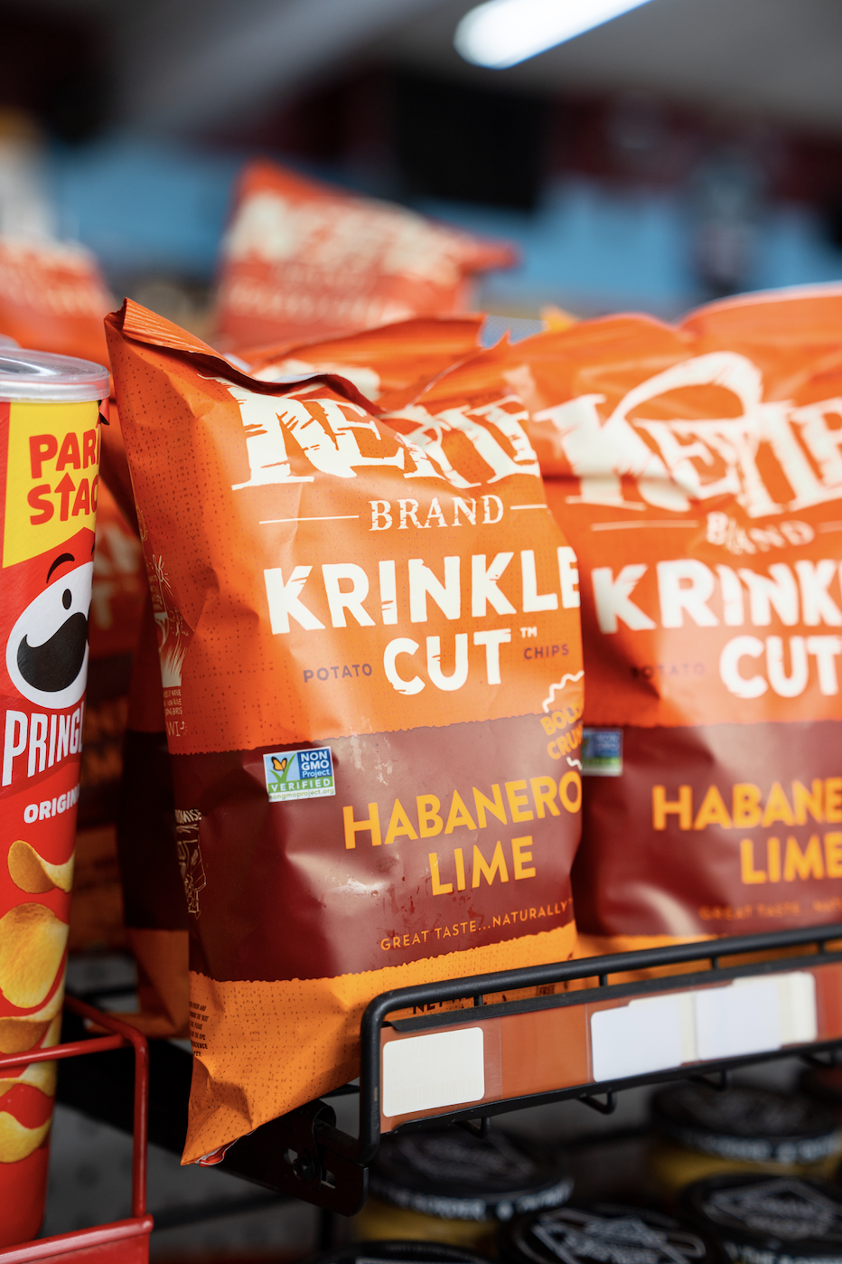 Bag of Krinkle Cut Habanero Lime potato chips on store shelf.