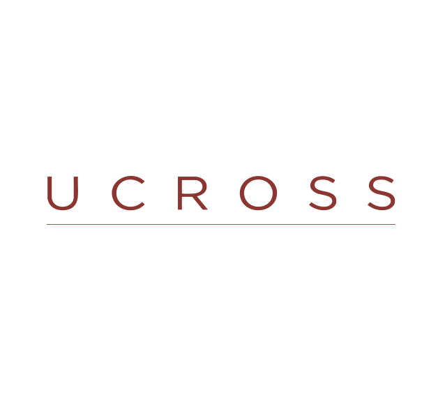 The image shows the word 'U C R O S S' in red uppercase letters with a red underline, on a white background.