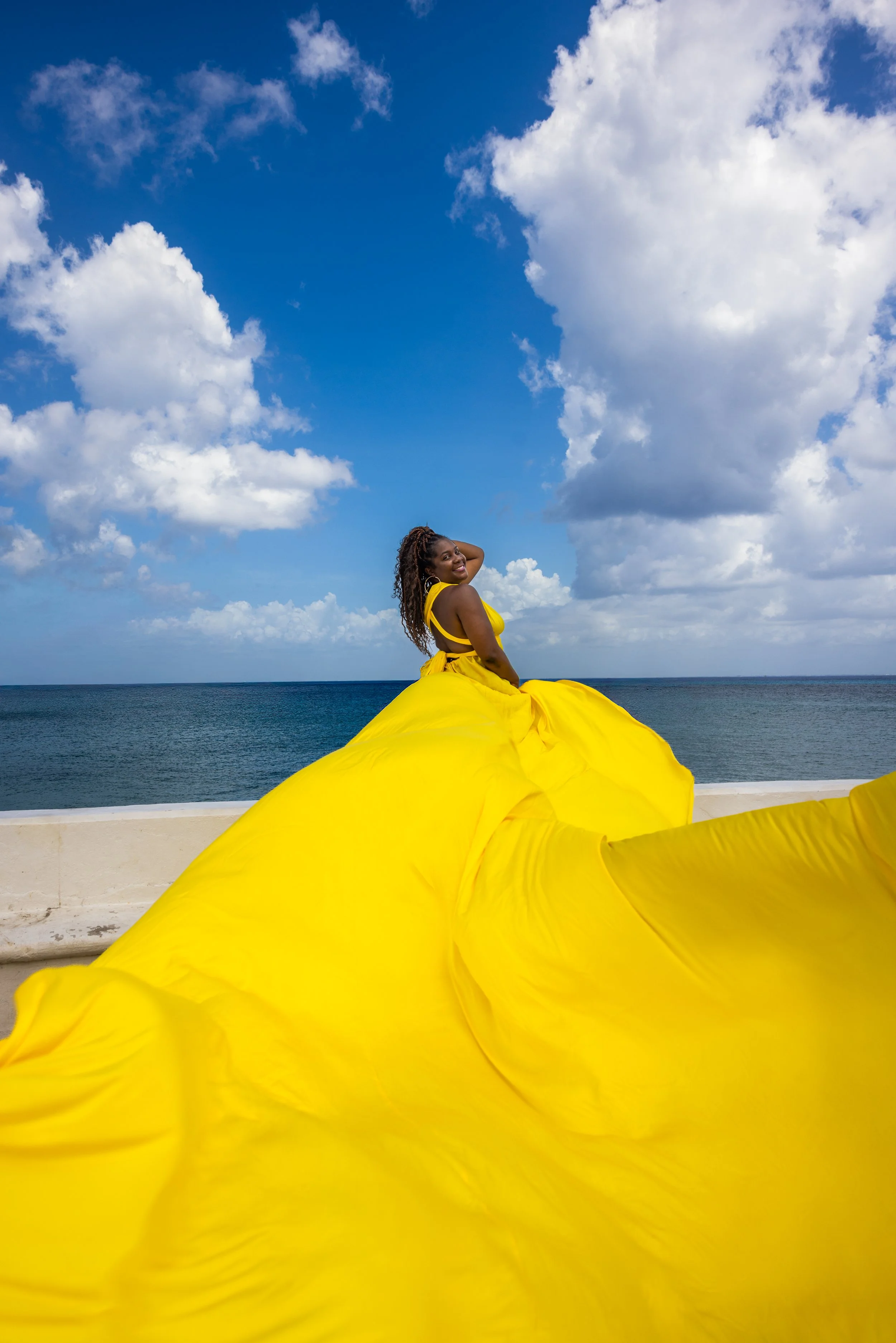 Woman in yellow flying dress posing in downtown Cozumel