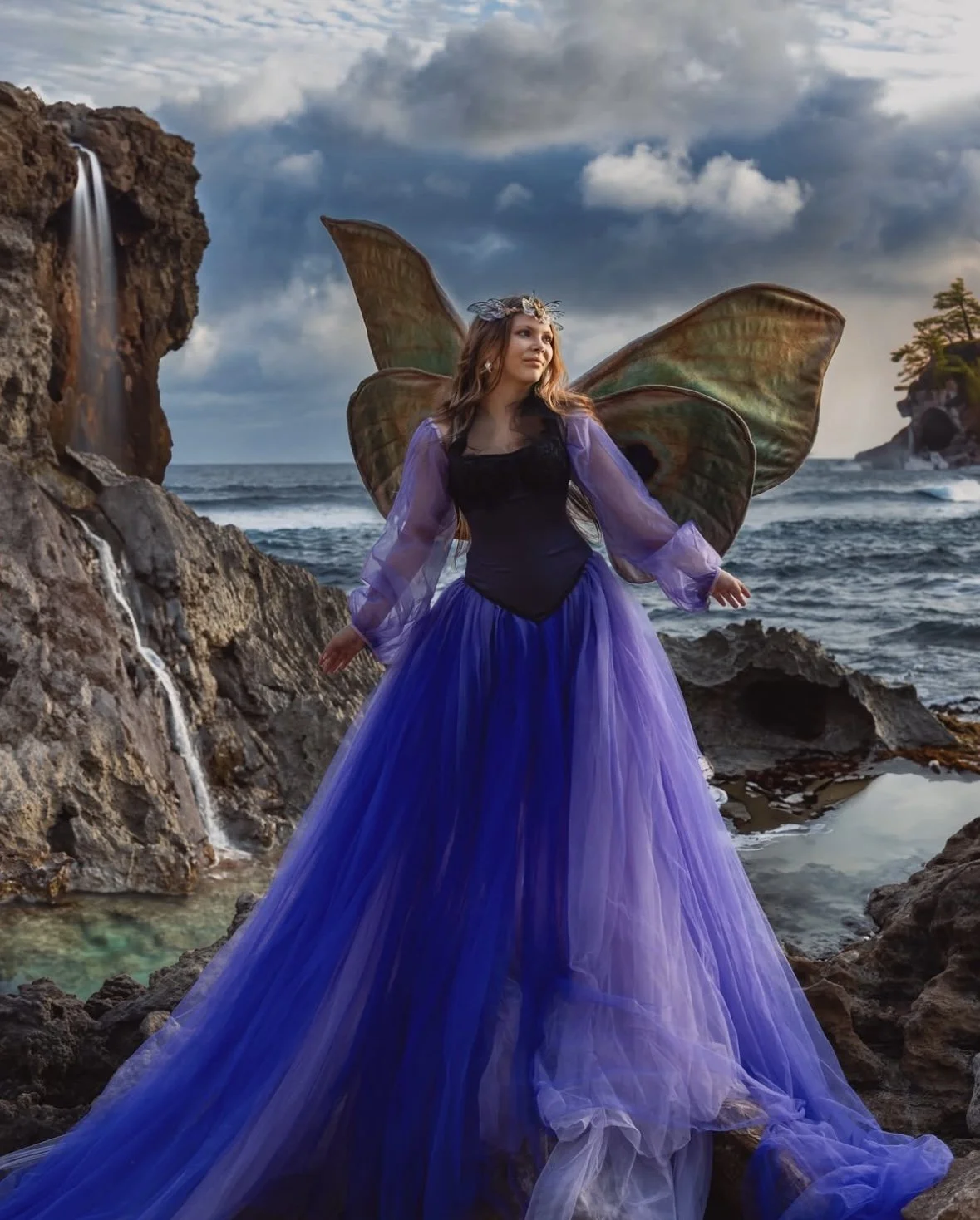 Sunset fantasy photoshoot of woman with wings on rocky shore in Cozumel