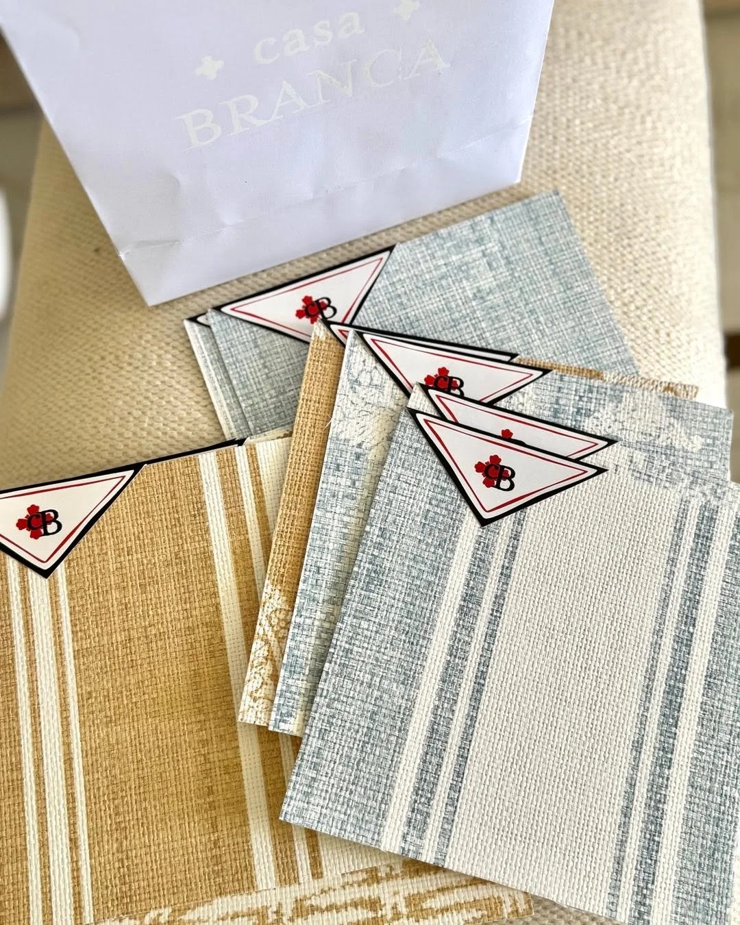 As I sift through these wallpaper samples, I remember something from art history class at Duke…
Centuries ago, kings and queens traveled with wallpaper.
Not the peel-and-stick kind—but embroidered fabrics, hand-painted panels, entire wa