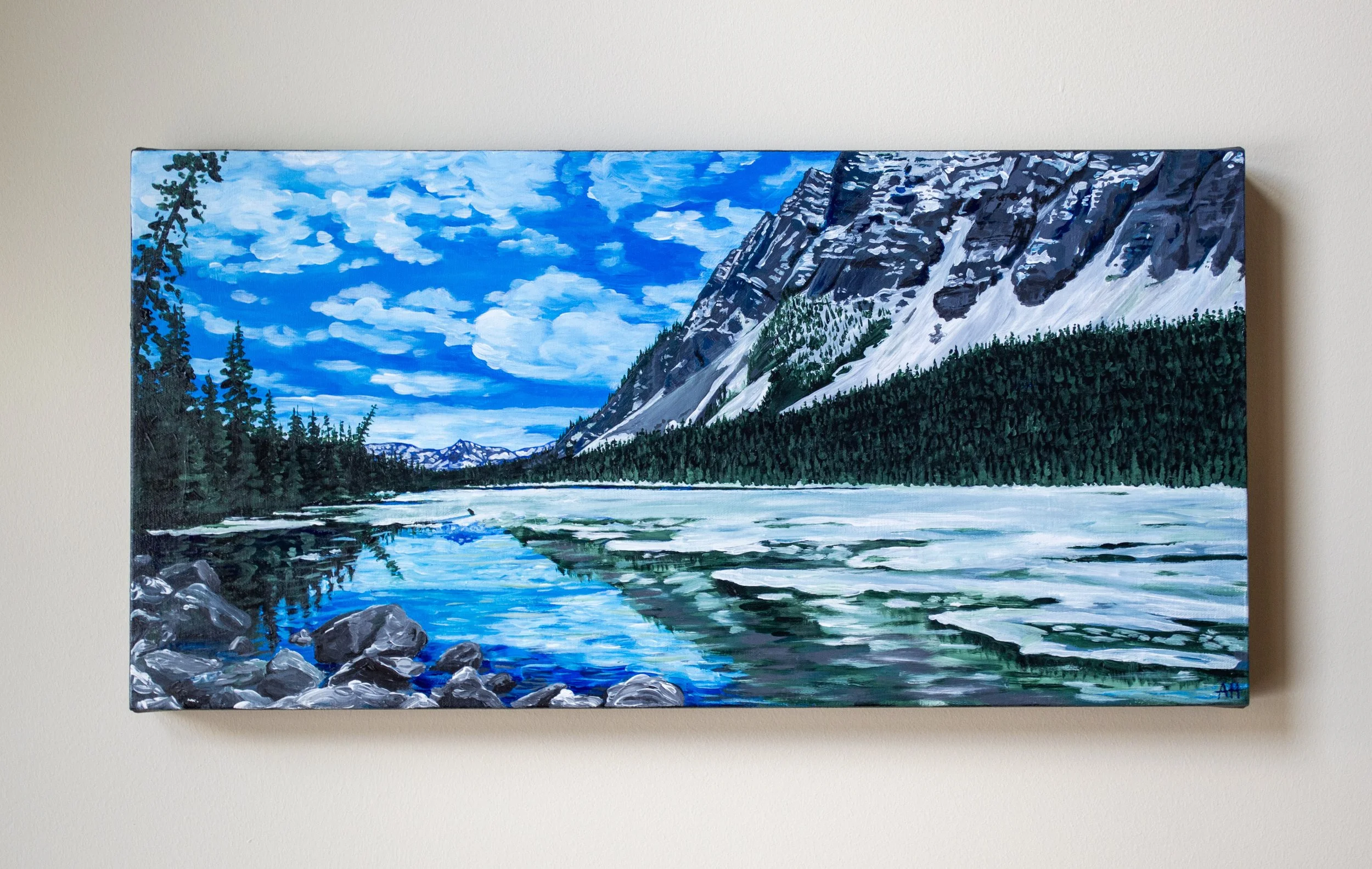 Painting of a scenic mountain landscape with a tranquil blue lake, snow-capped mountains, evergreen trees, and a cloudy sky.