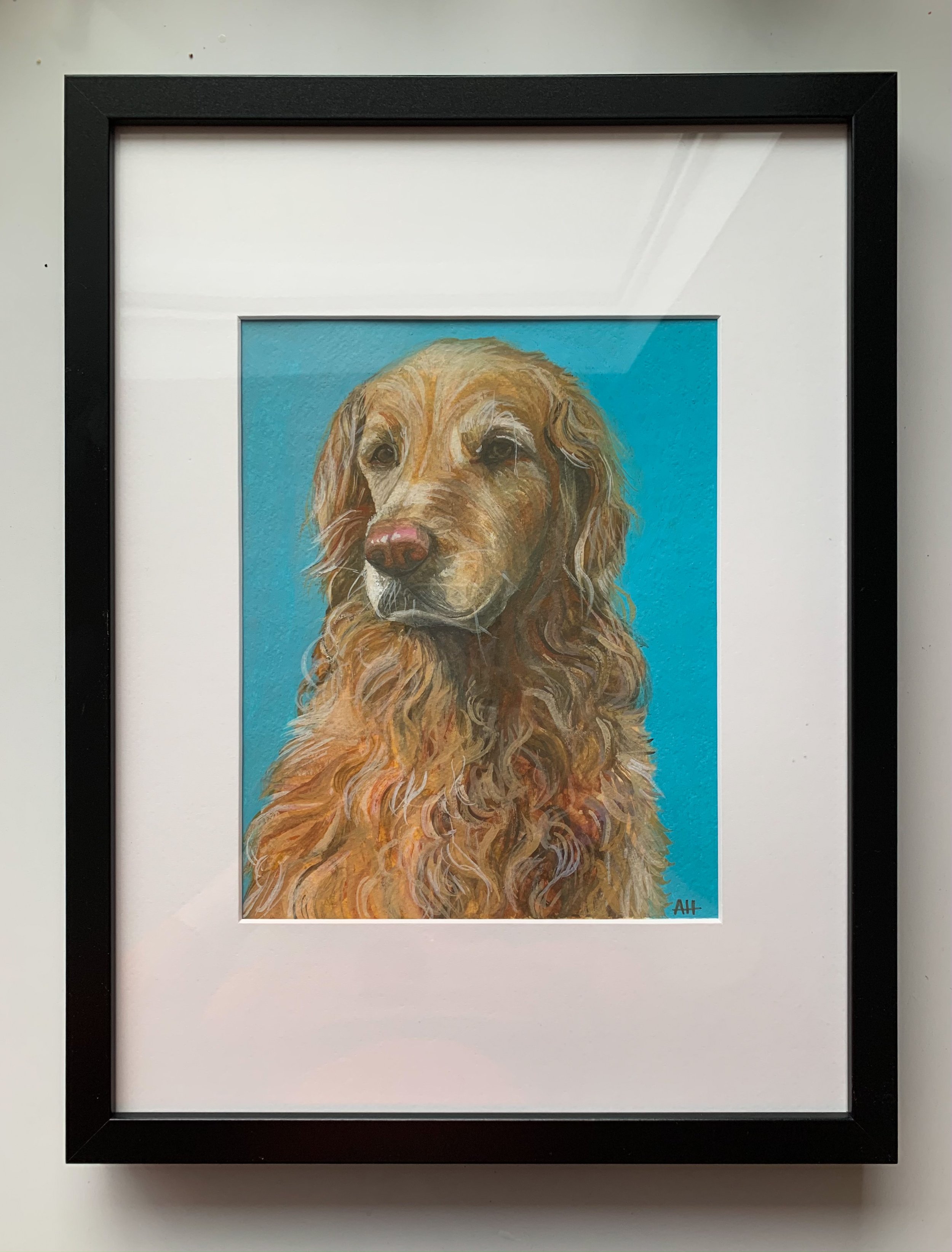 Framed painting of a golden retriever on a blue background