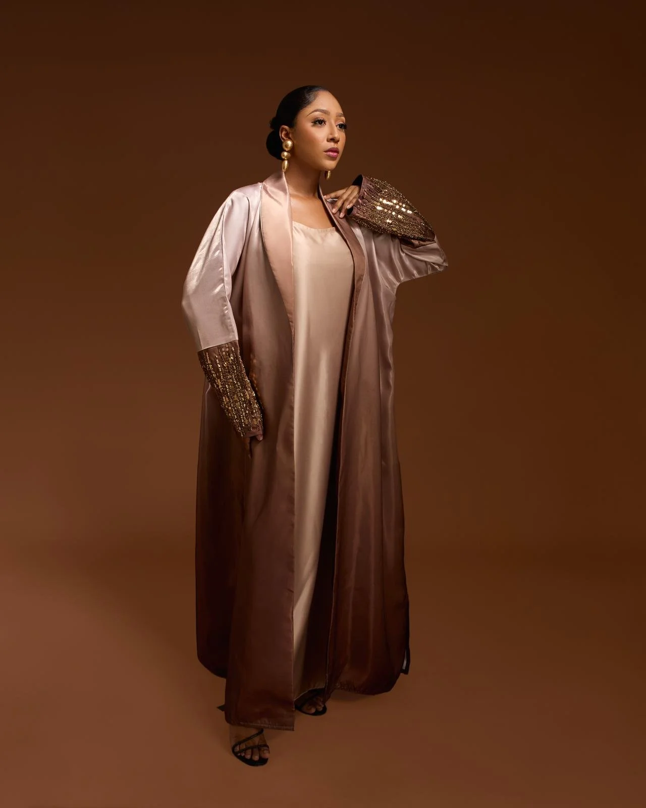 The Layali Elegance Mocha Dress. Elegant bronze satin abaya with sequin sleeves for eveningwear.