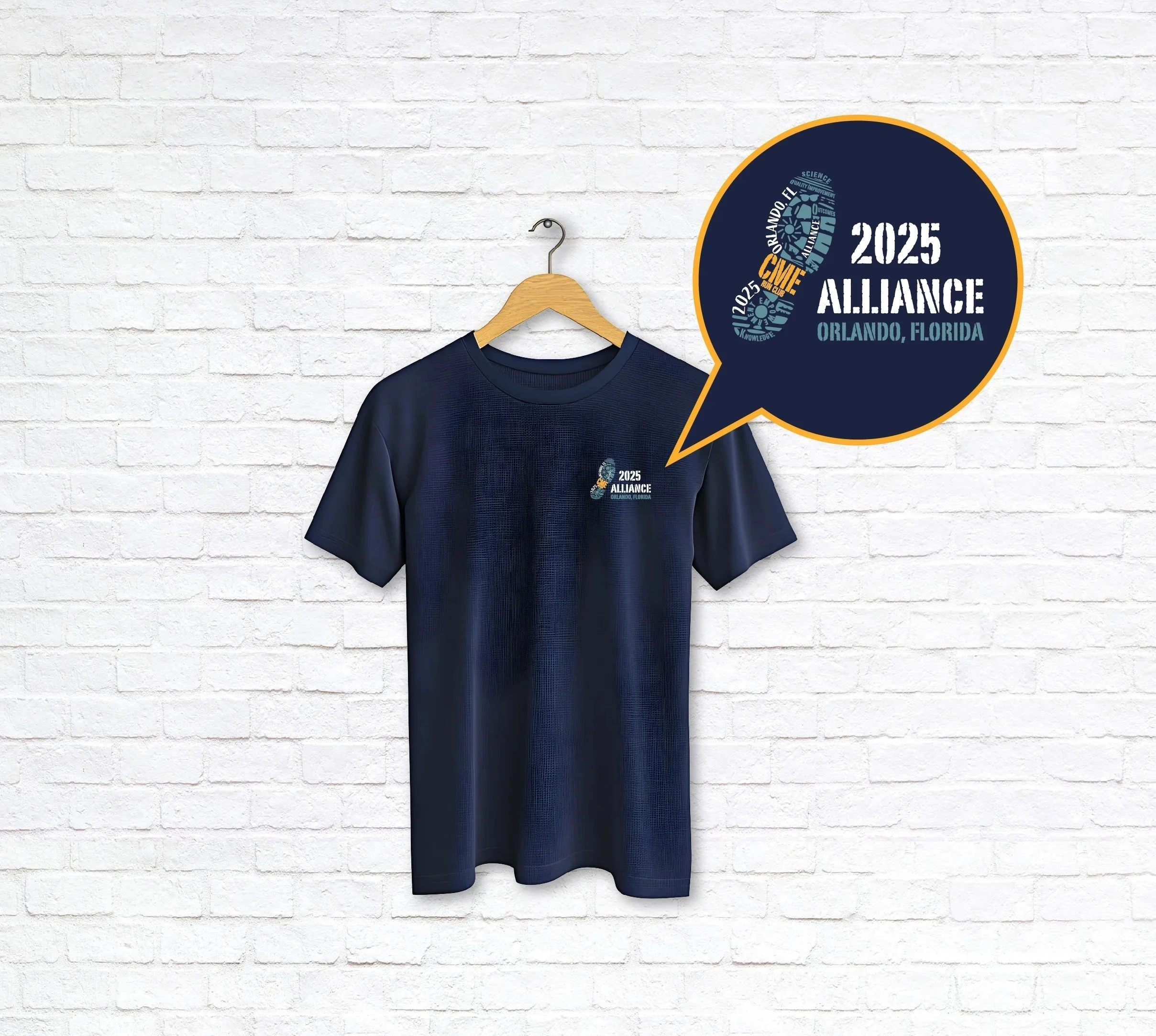 A navy blue T-shirt hanging on a wooden hanger against a white brick wall. The T-shirt has a small graphic on the upper left side that says '2025 Alliance Orlando, Florida' with a circular logo.