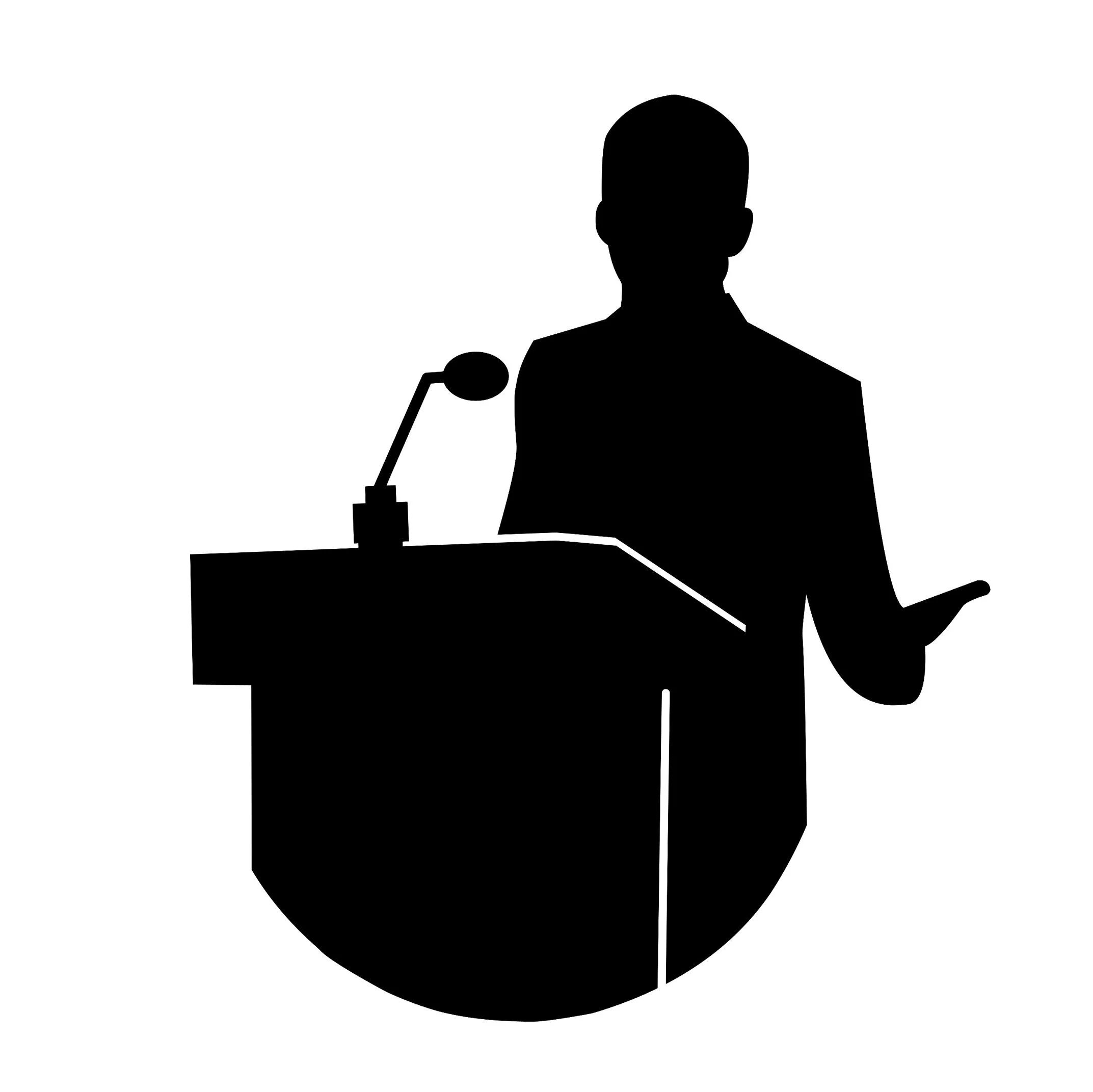 Silhouette of a person speaking at a podium with a microphone.