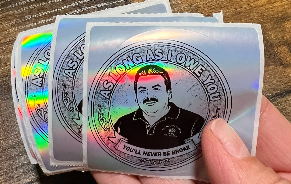 Silver sticker that says 'As long as i owe you, you'll never be broke'