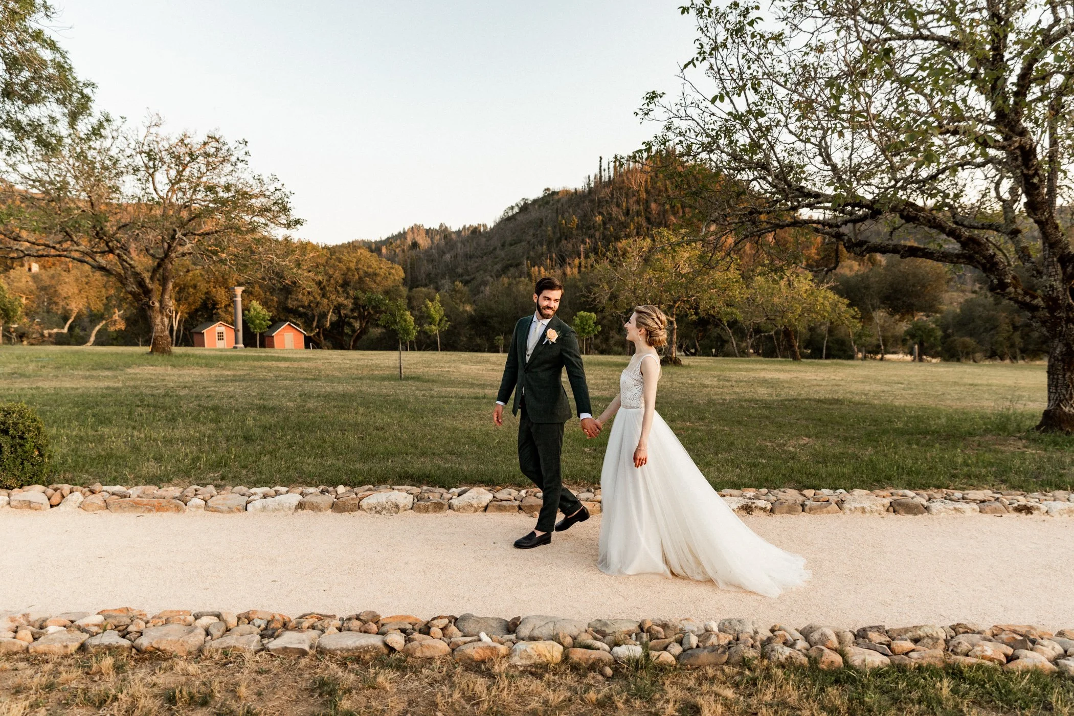 Bride and groom holding hands as they walk Triple S Ranch, Calistoga, California