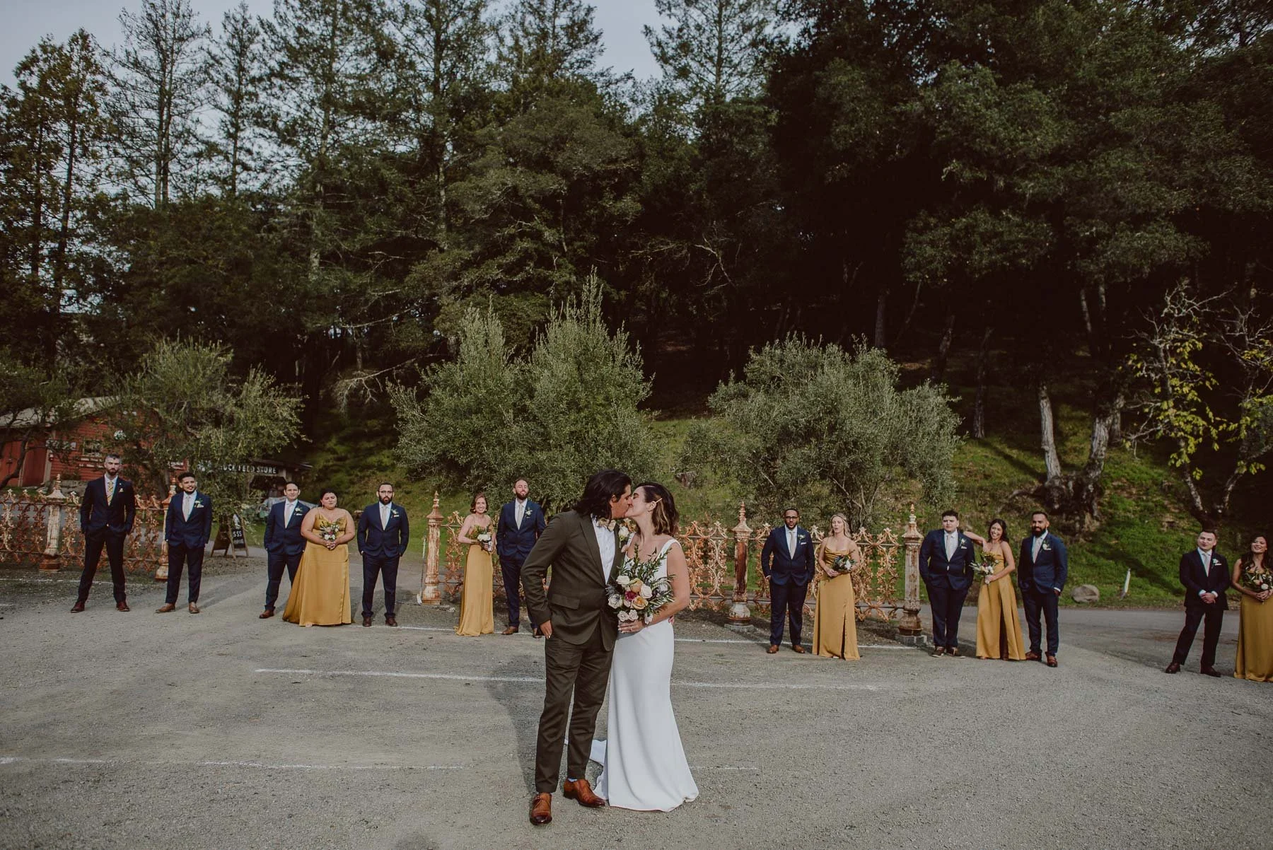 Darny and Danny, Bride and Groom, kissing together with wedding party at Triple S Ranch in Calistoga California