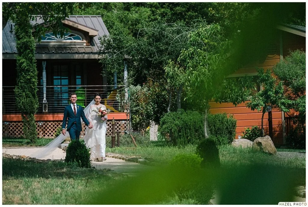Bride and groom walking to ceremony at Cate and Evan's wedding at Triple S Ranch, Calistoga, California