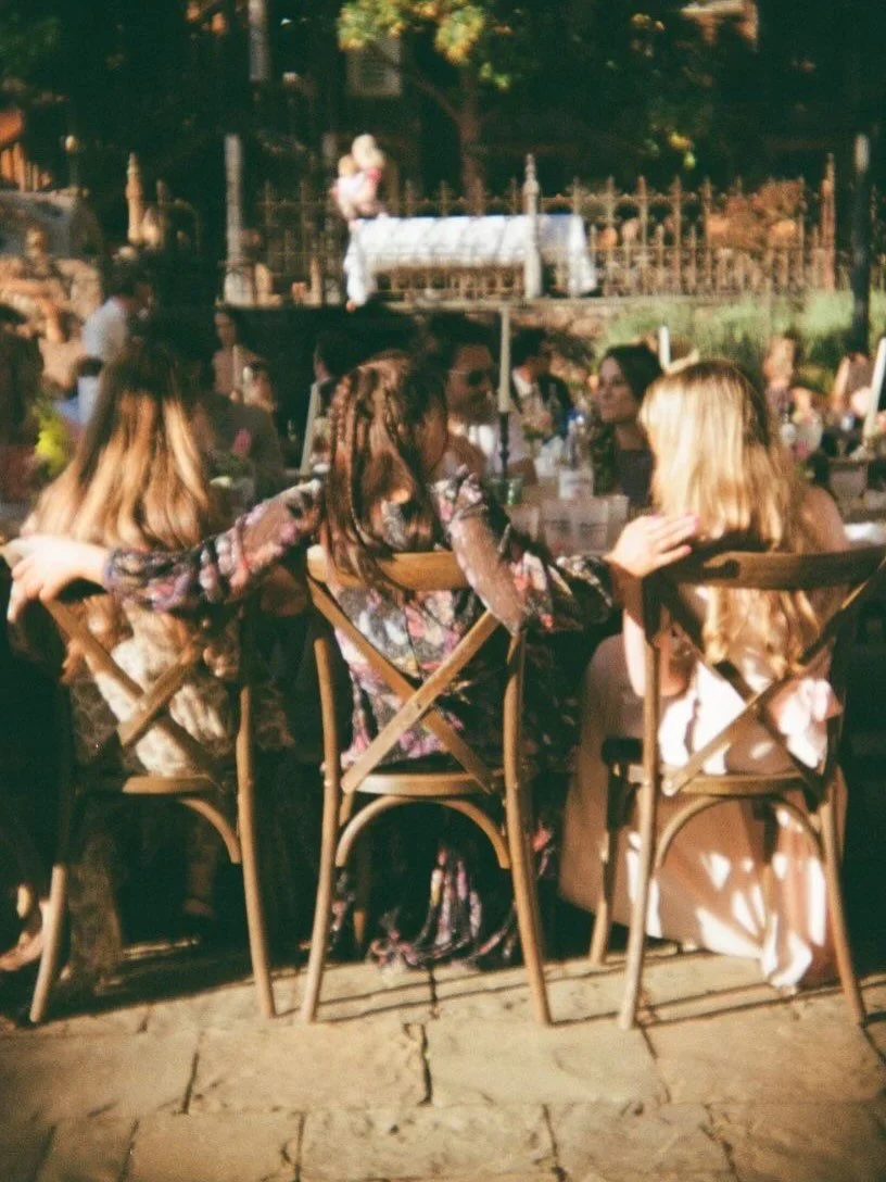 Imagine this.

Amber light spilling through the trees, 
chilled champagne sweating, catching the late afternoon sun, laughter softening into long glances across the table. 
The warm skin kissed by golden light. And the ease of people settling into ce