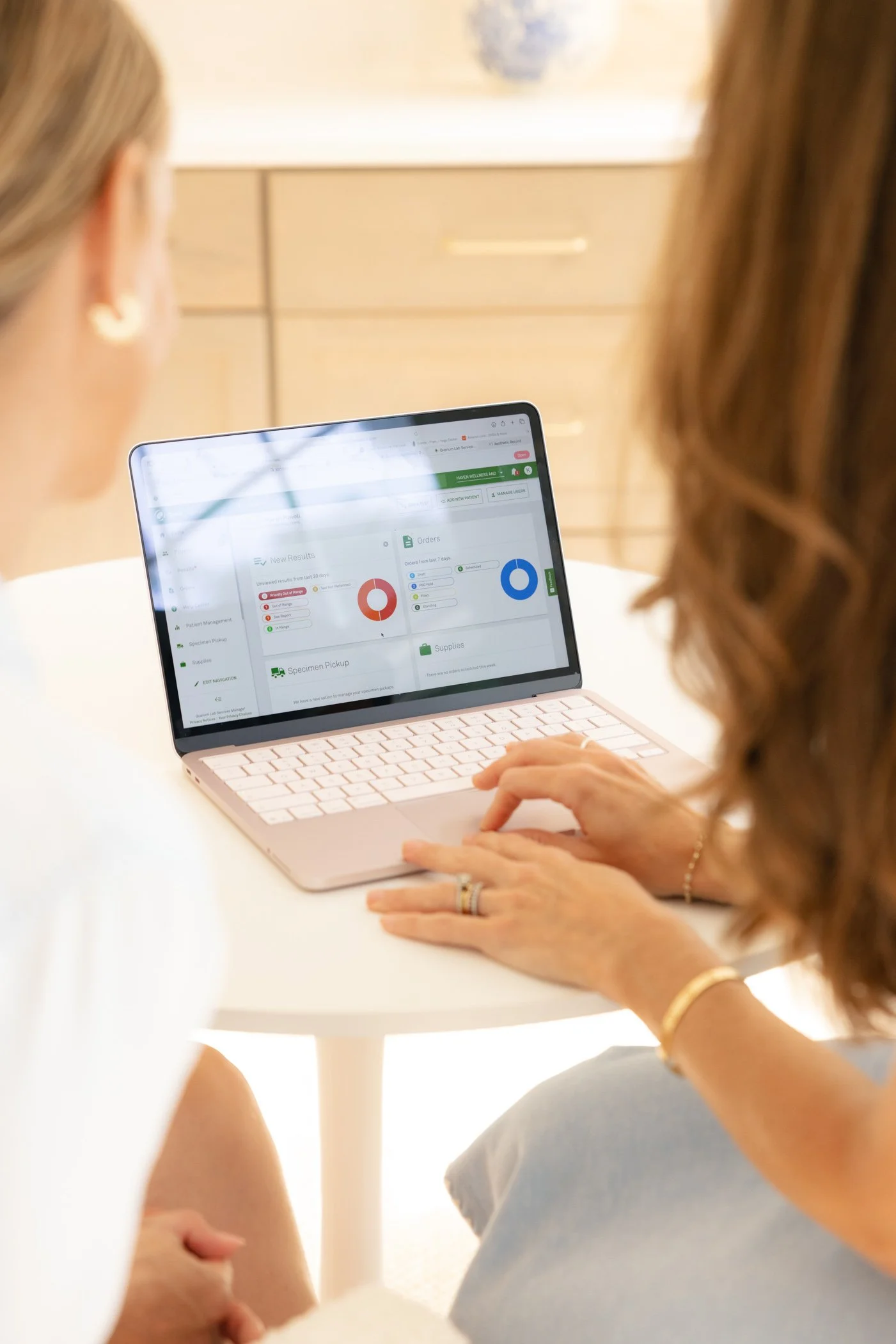 Karen Powell, FNP-BC, reviewing lab results with a patient during a midlife wellness visit covering hormone therapy and GLP-1 treatment at Haven Wellness & Aesthetics, Fair Haven NJ