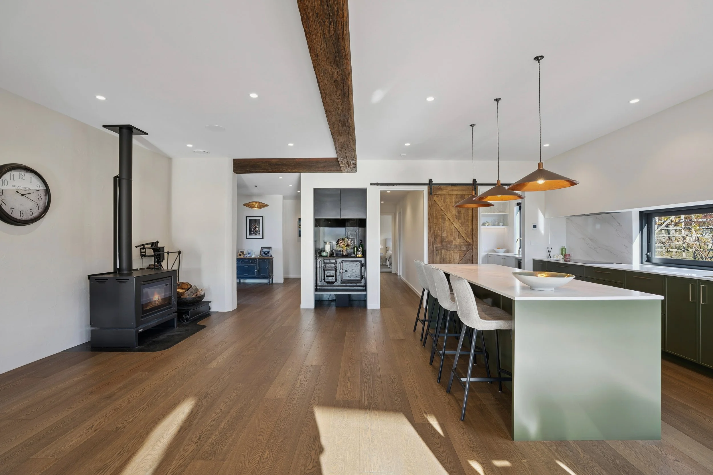 Moscato Oak in living area with log burner and kitchen cabinetry