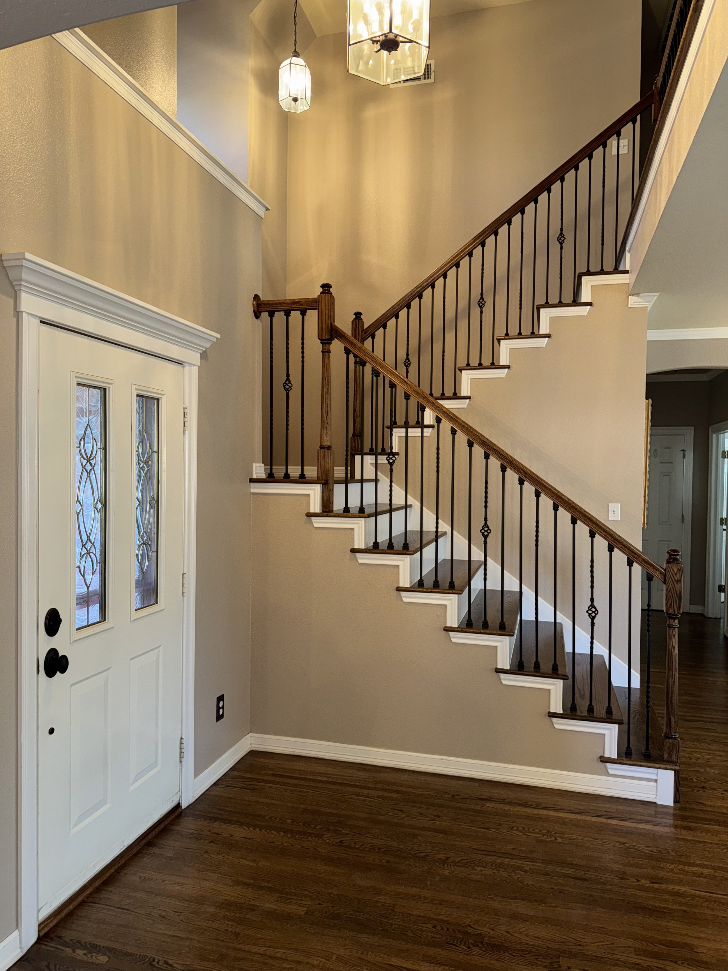 Red Oak Staircase with coffee brown stain and oil base polyurethane. Painting services were also provided in the picture.
