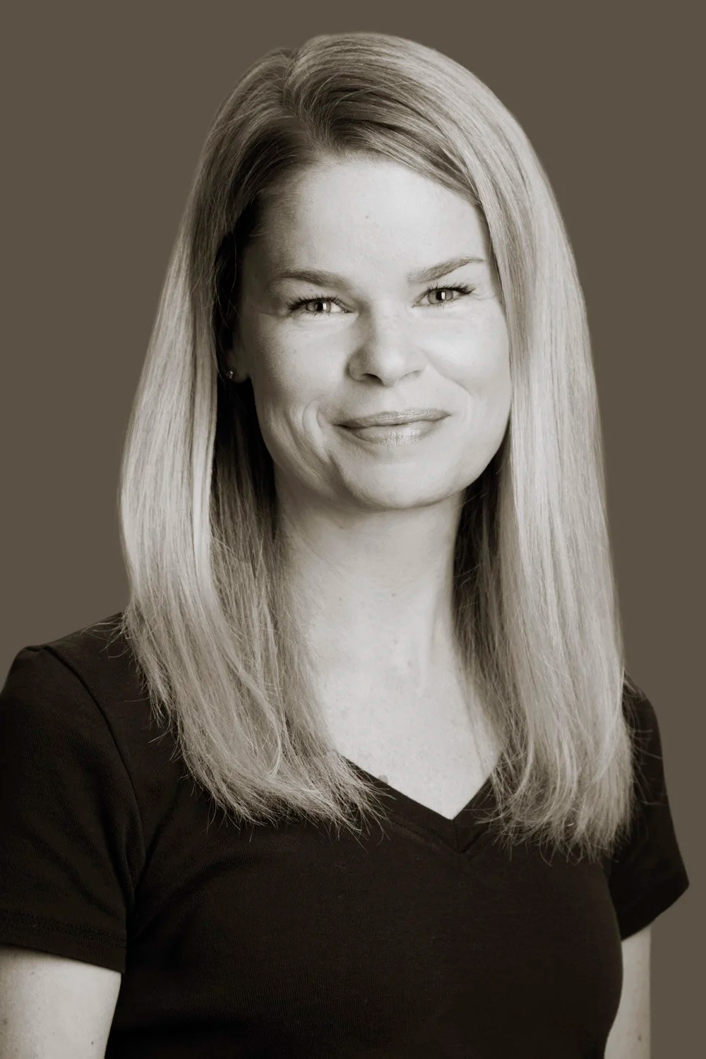 Black and white portrait of Kristy-Lynn Corvino, registered massage therapist and owner of Chilligo Blooms Massage & Wellness