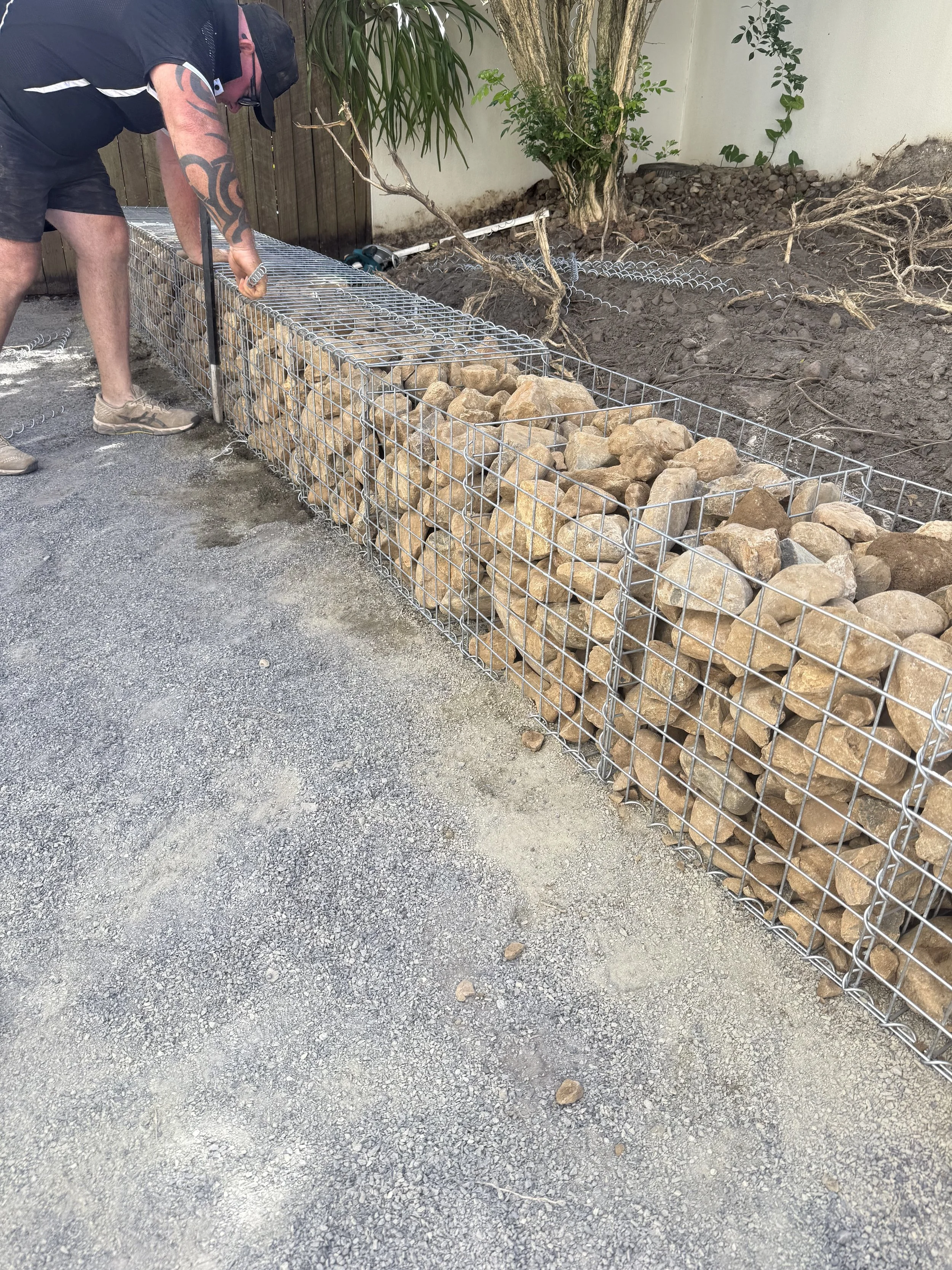 Small rock retaining walls are a great way to separate the different zones in your backyard.