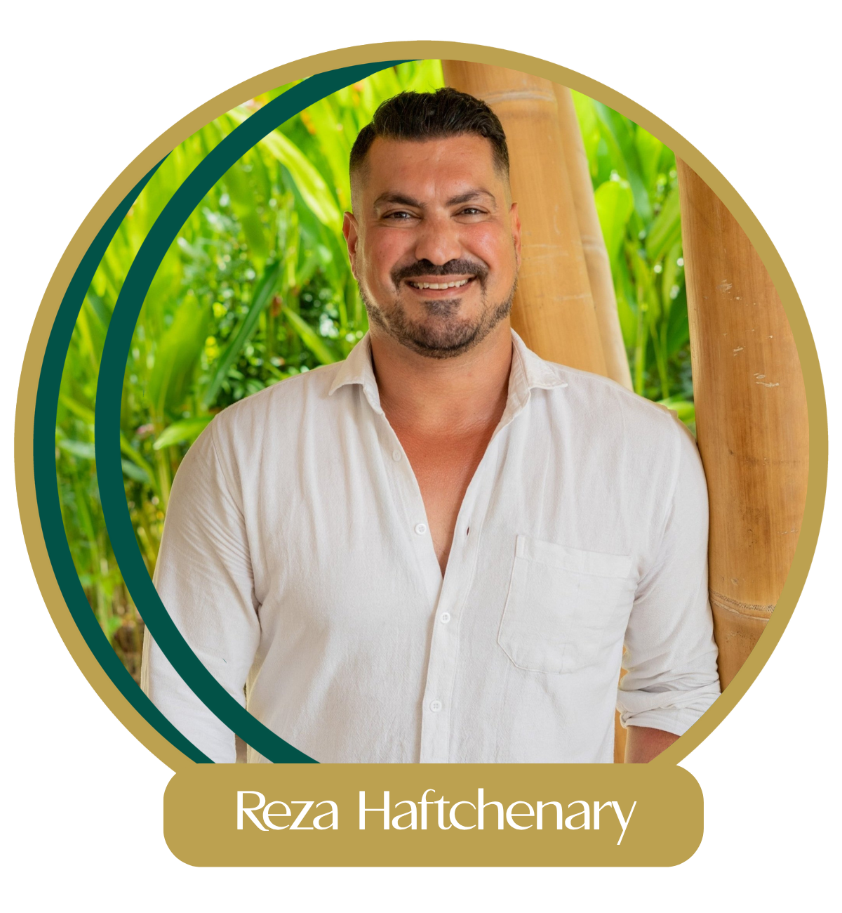 Man with dark hair and beard wearing a white shirt, outdoors with green plants and bamboo in the background, smiling.