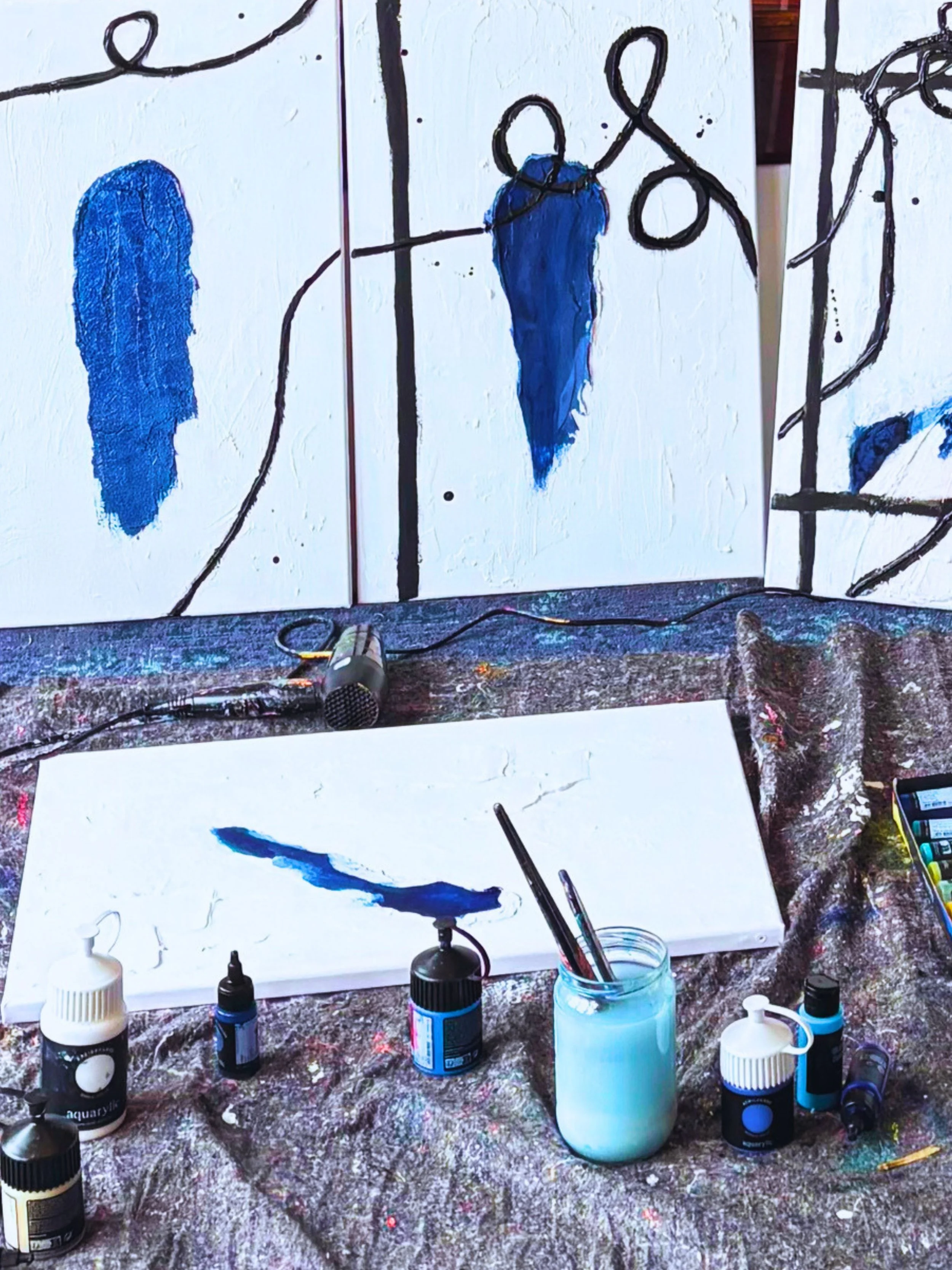 Artist studio with painting materials and canvas in progress during the creation of the Unmaking series