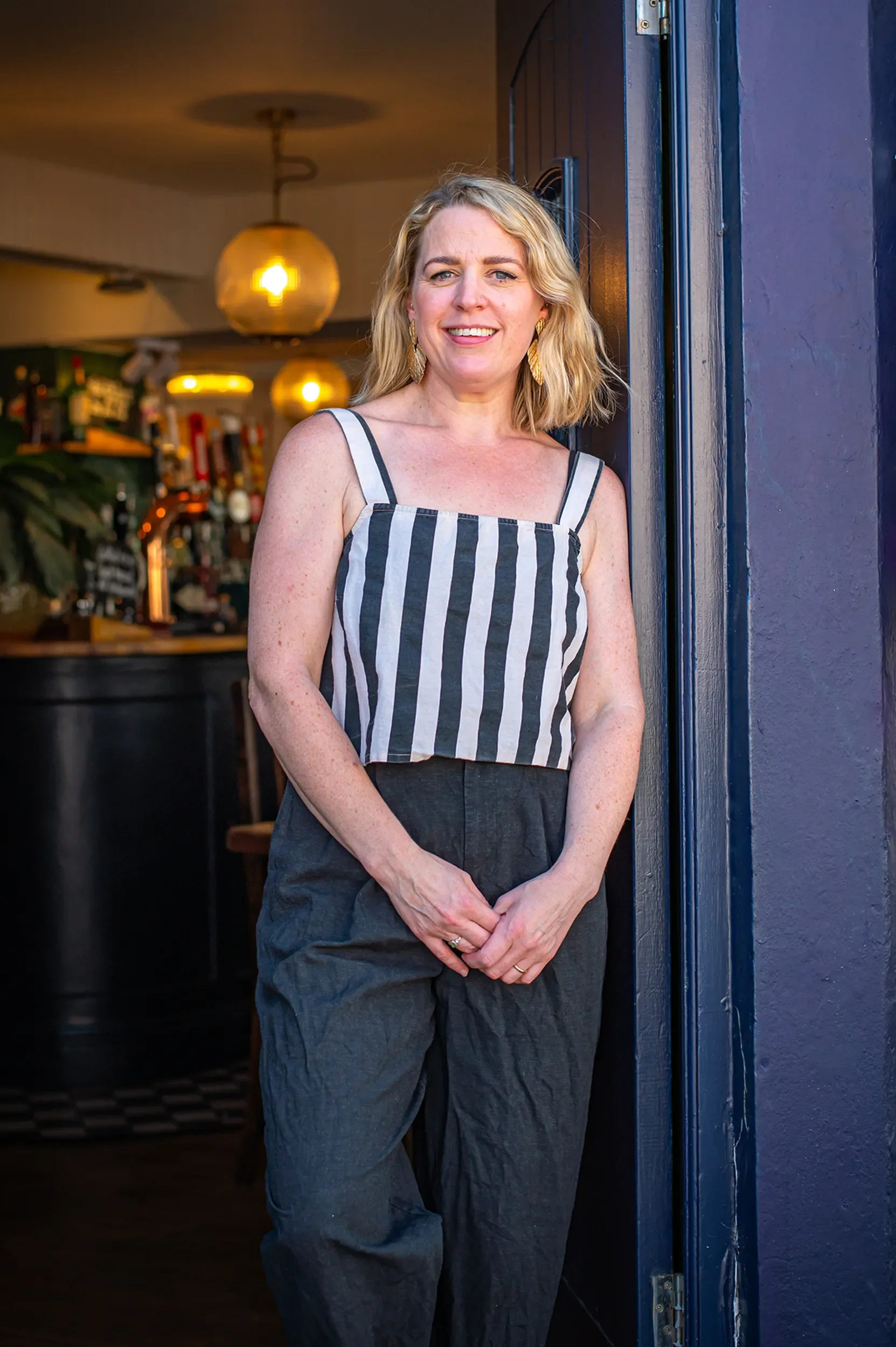 Portrait of Amy, co-owner of Bristol Pie Society, smiling in the doorway of The Gloucester Old Spot pub in Bristol.