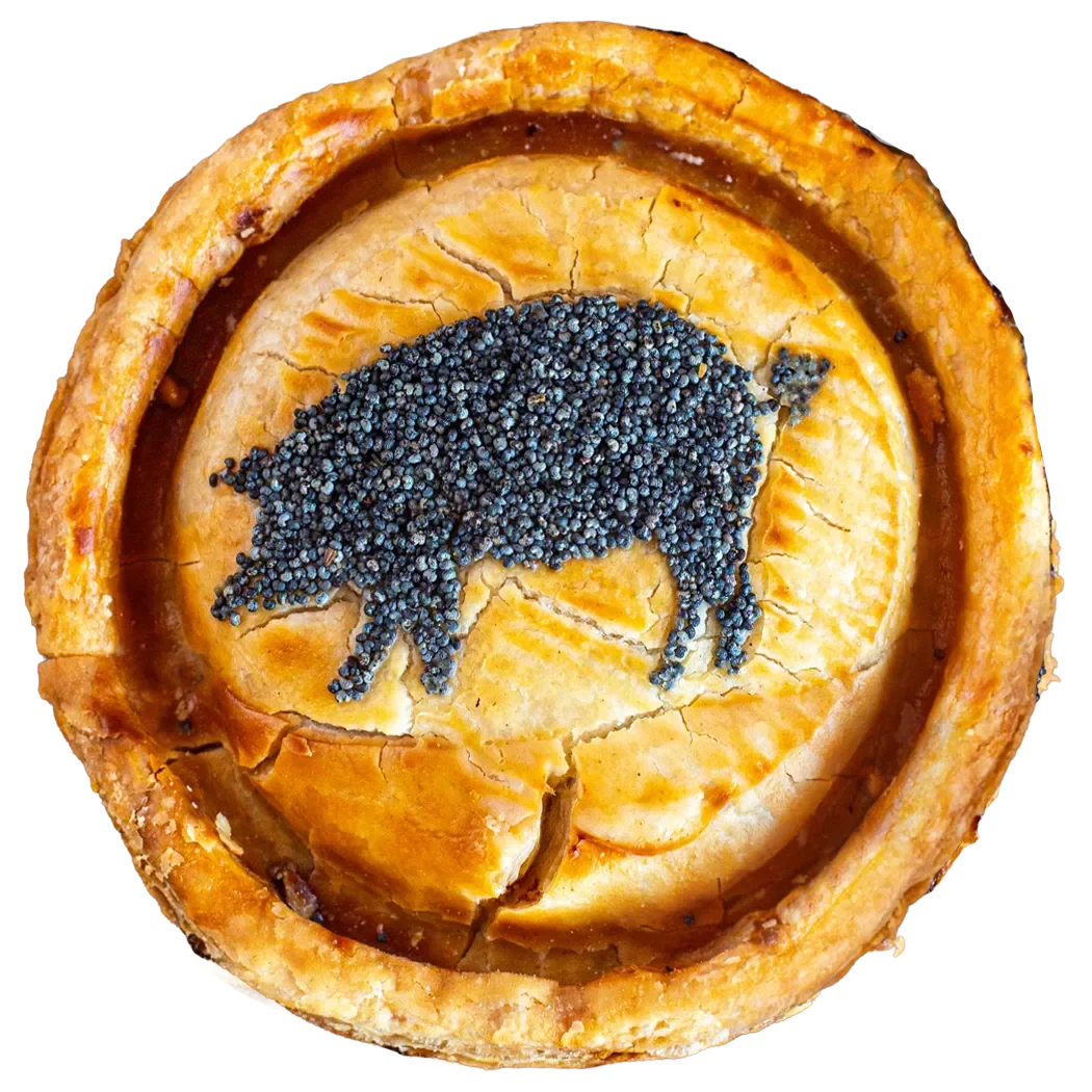 Handmade bacon pie from Bristol Pie Society featuring a golden crust and a signature poppy seed pig design.