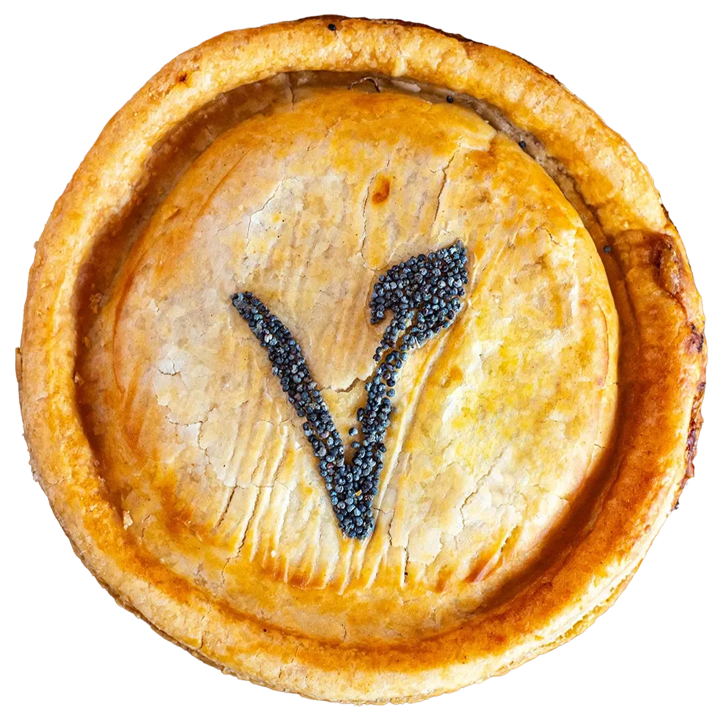 Handmade vegan pie from Bristol Pie Society featuring a golden pastry crust and a signature poppy seed 'V' leaf design.