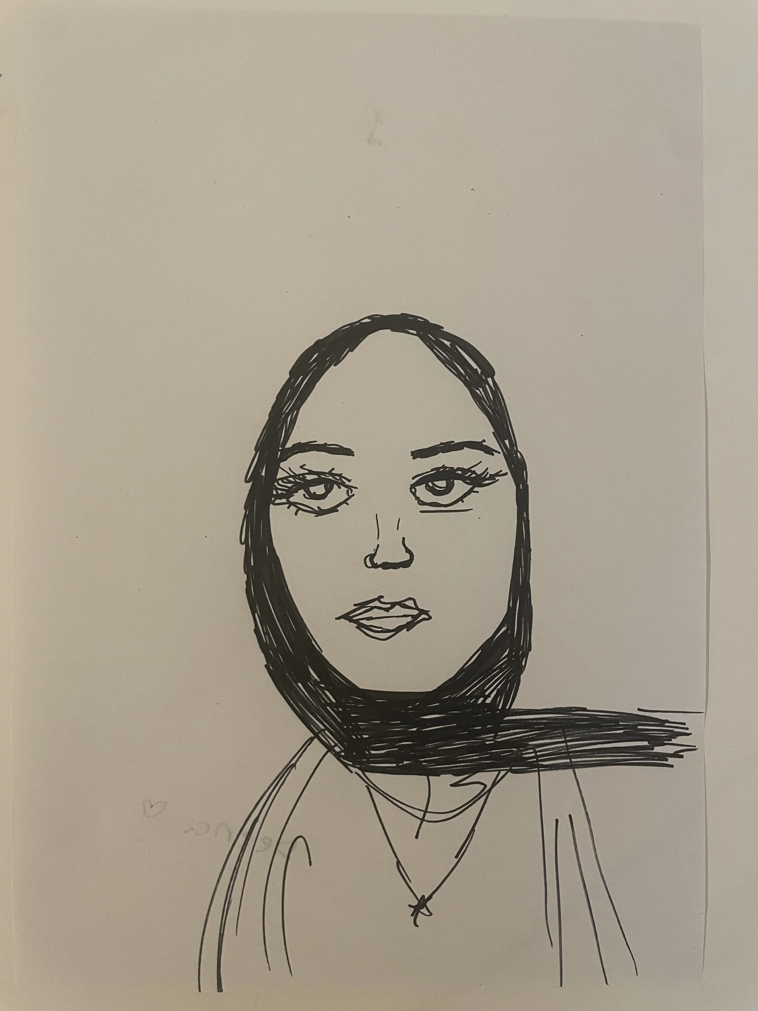 A face looking  directly out, wearing a black headscarf.