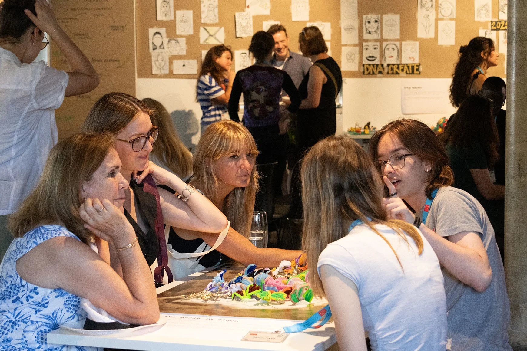 DNA CREATE participants and exhibition guests discuss the Brain in Bloom project.