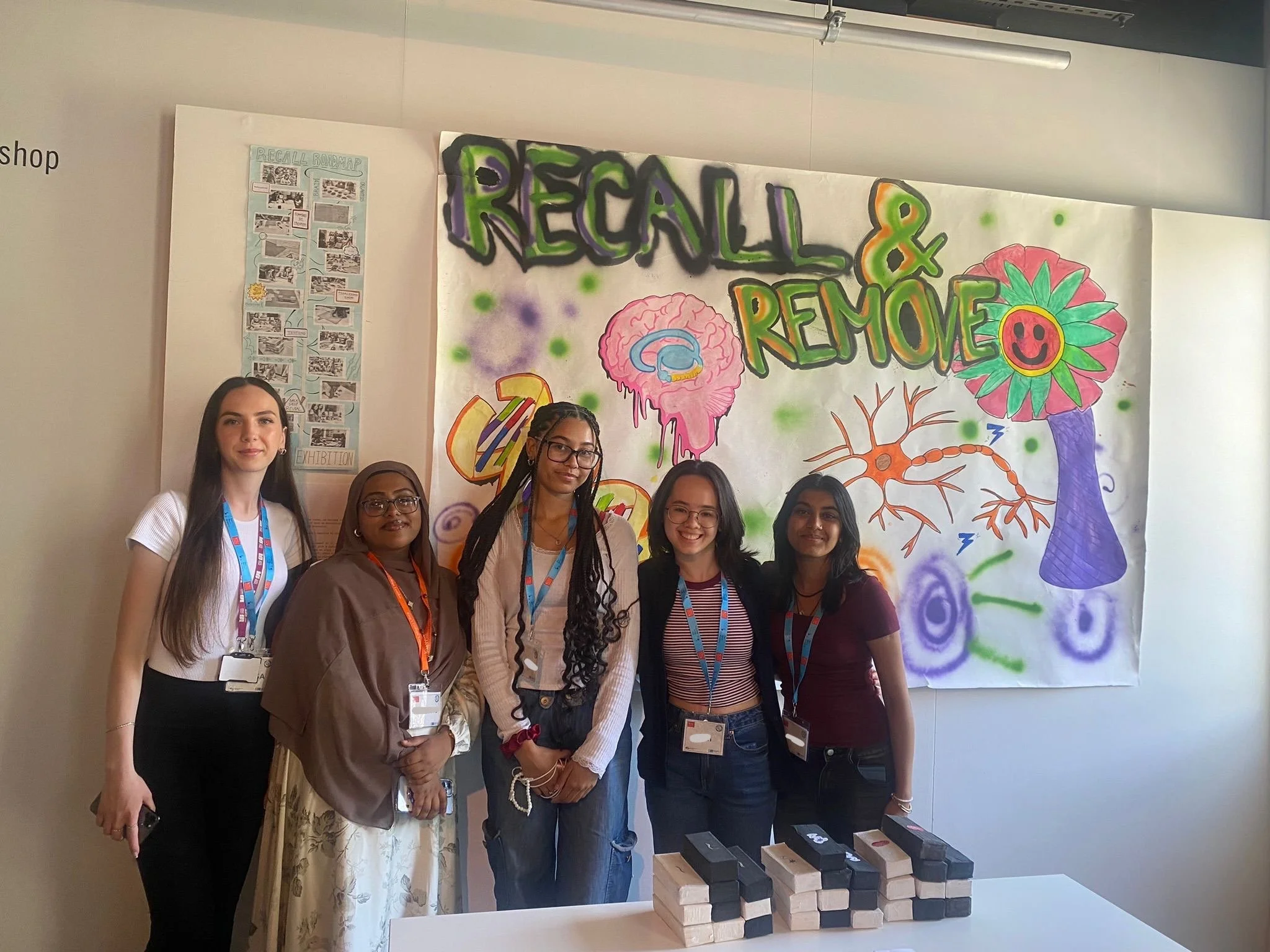 The Remove & Recall group stand in front of their group project.