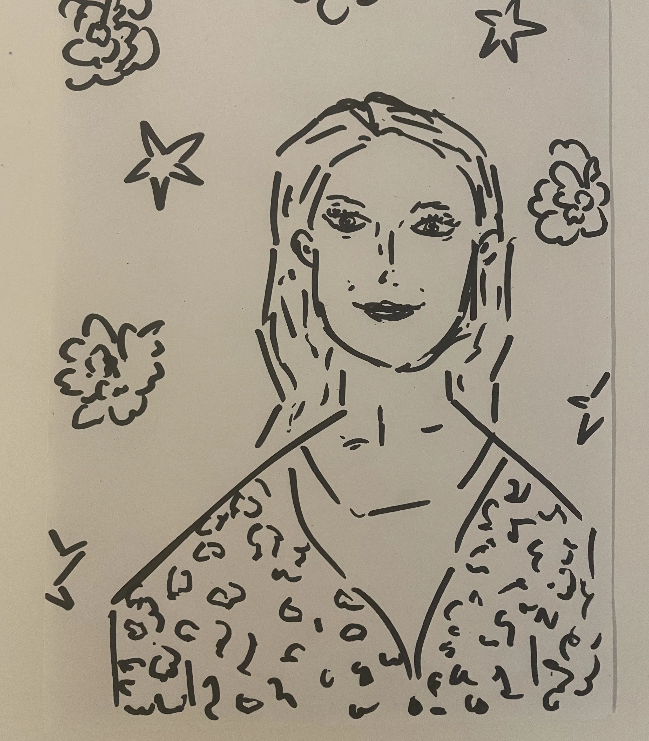 A person in a patterned top surrounded by flowers and stars.