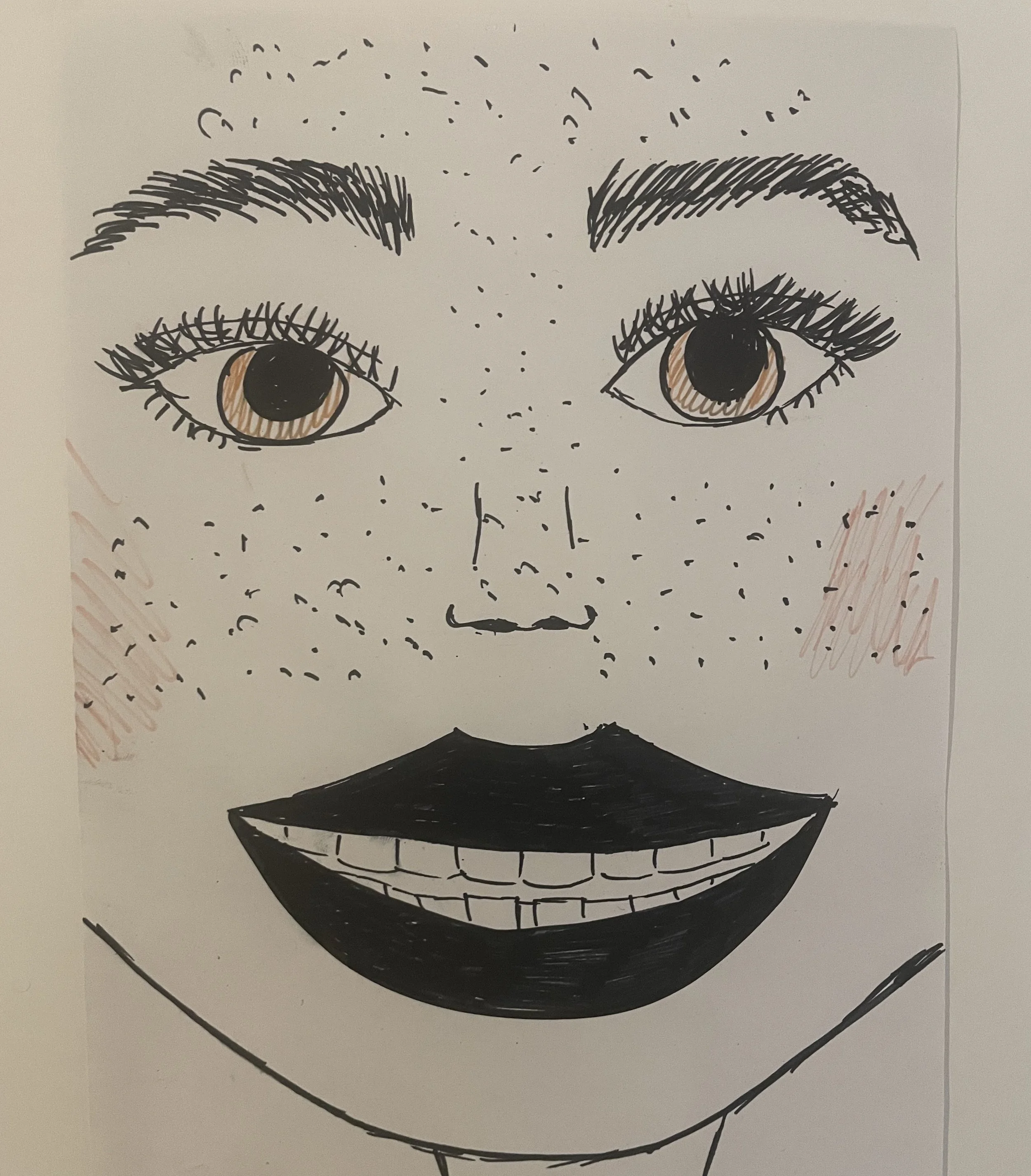 A smiling face with freckles.