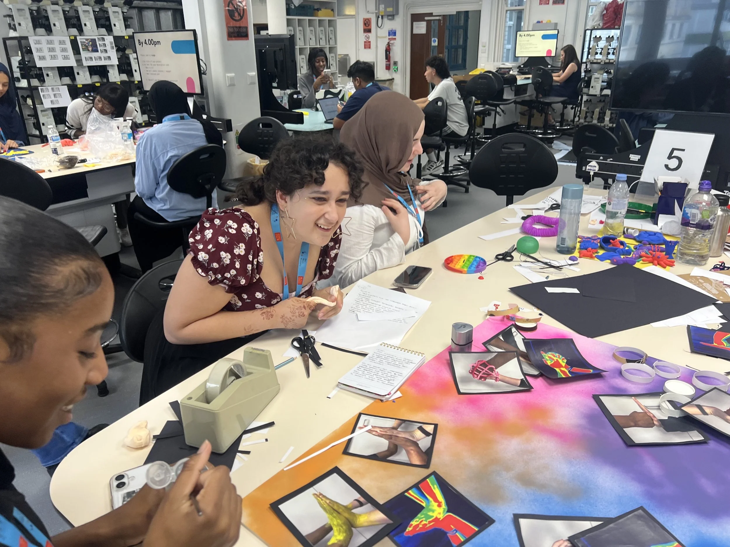 A group of DNA participants laugh as they work on their group project.