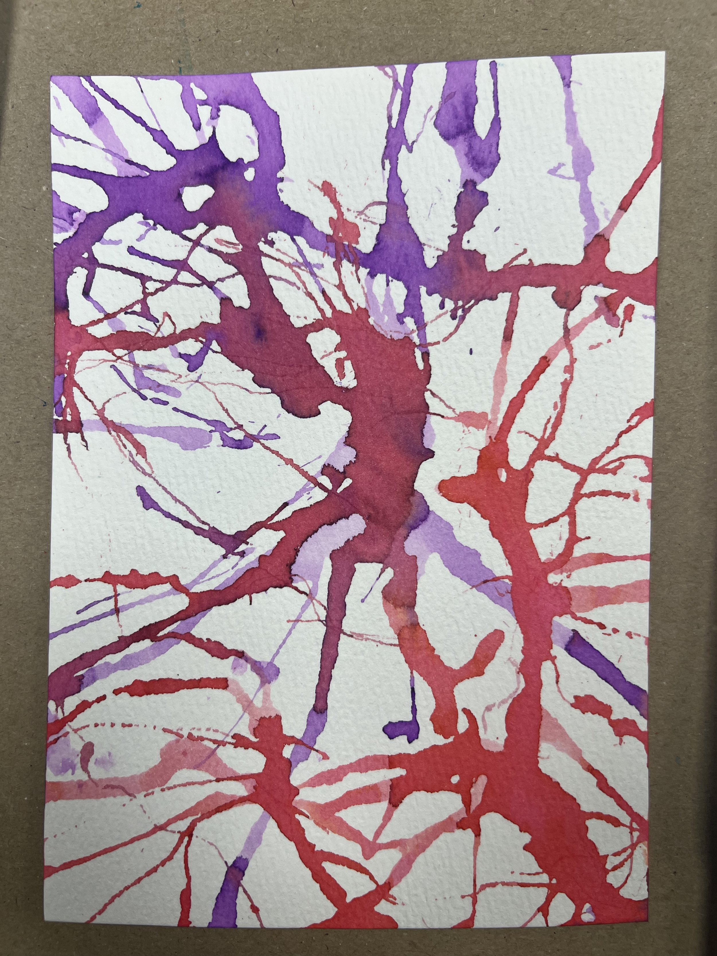 A ink neuron image with patterns of ink in purple and red.